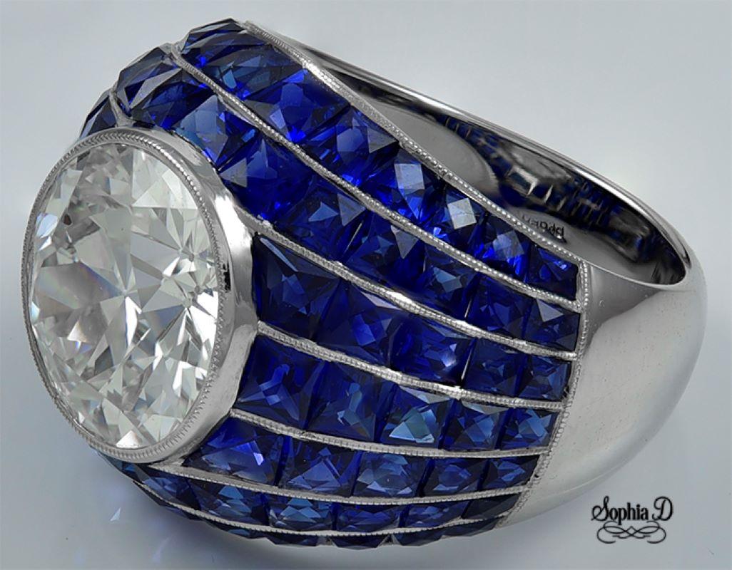 An Art Deco bombe ring set in platinum by Sophia D. that features a 5.03 carat center diamond accentuated with 7.25 carat of blue sapphire.

GIA: I-VS2 GIA: 2125563307

Sophia D by Joseph Dardashti LTD has been known worldwide for 35 years and are