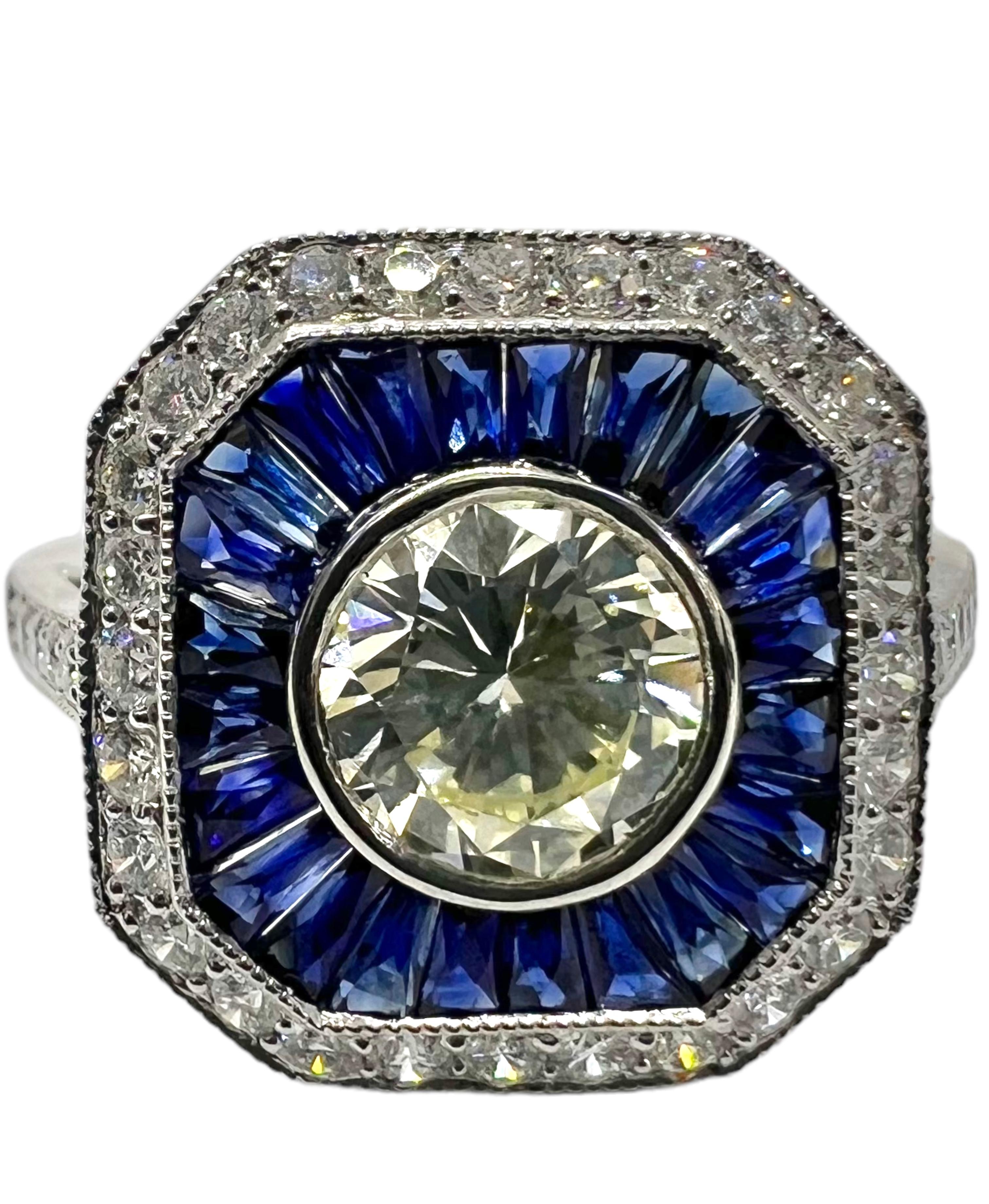 An art deco platinum ring with O-P VS2 .86 carat center round diamond accented with 0.84 carat blue sapphire and 0.43 carat small round diamonds.

Sophia D by Joseph Dardashti LTD has been known worldwide for 35 years and are inspired by classic Art