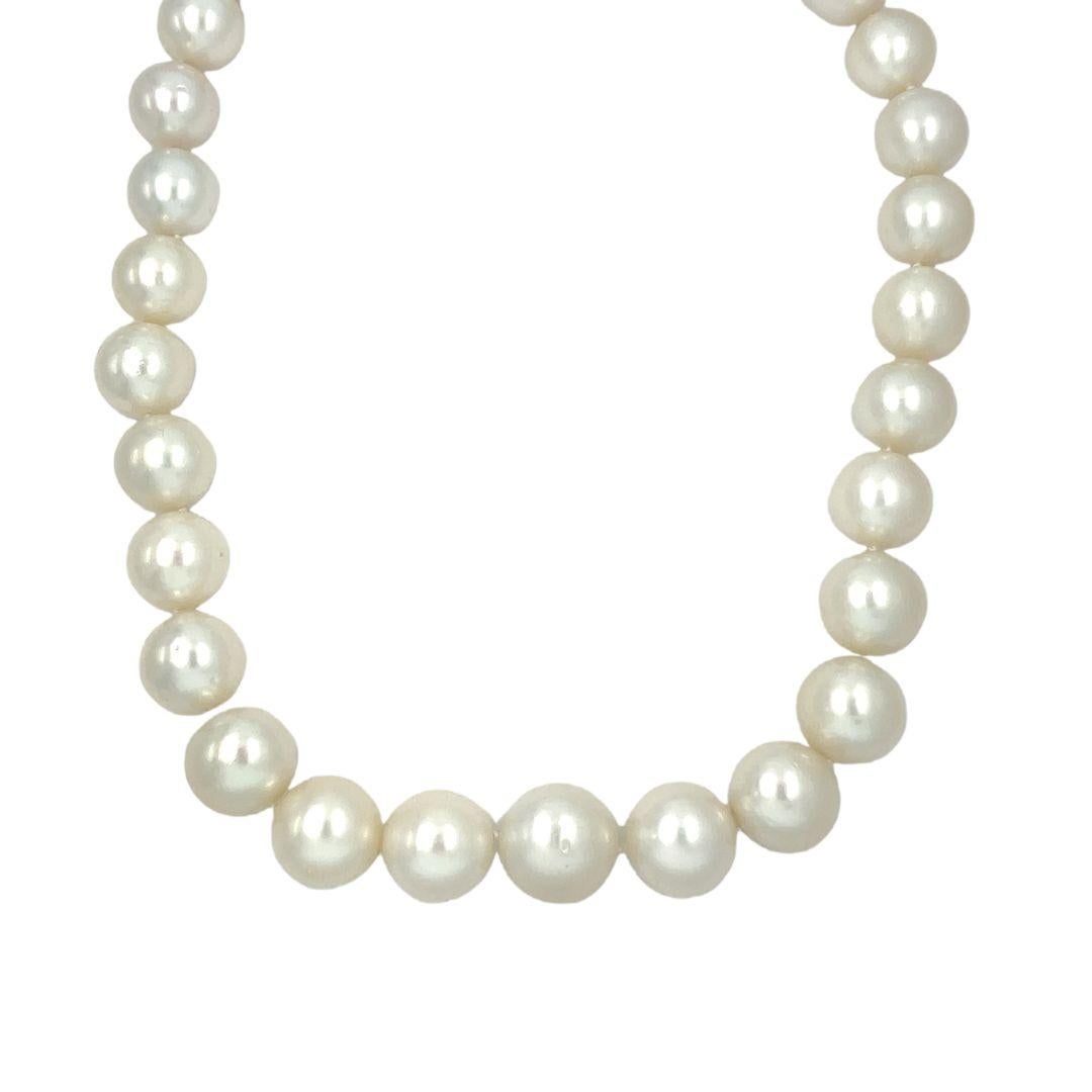 This elegant necklace is adorned with 29 graduated white South Sea pearls, ranging from 15mm to 12mm. A platinum round sphere screw clasp, gracefully pavé set with round diamonds totaling around 4 carats (G-H color, VS clarity), adds a touch of