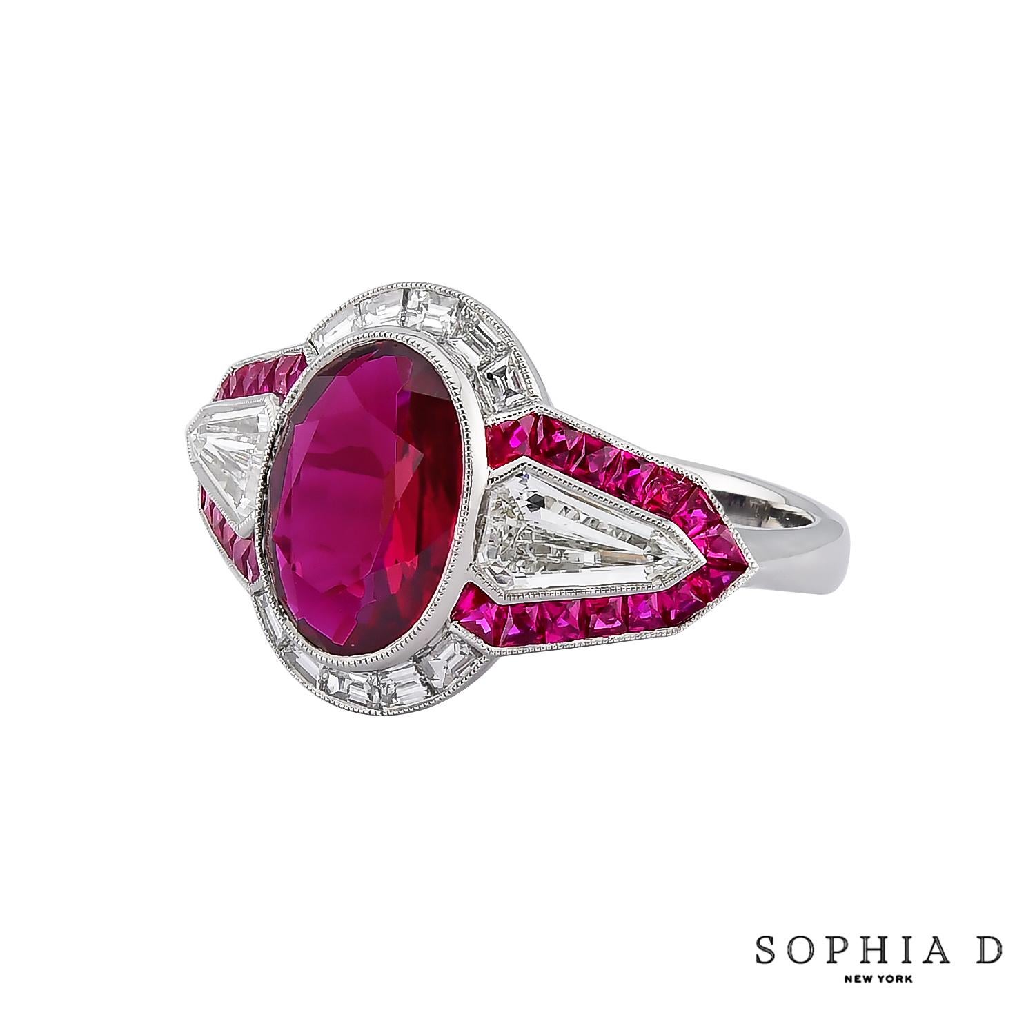 A striking Art Deco ring featuring a 2.07-carat oval ruby, framed by 0.72 carats of baguette-cut diamonds and 0.27 carats of round diamonds. The geometric design is further enhanced by 0.55 carats of French-cut rubies, adding depth and contrast.