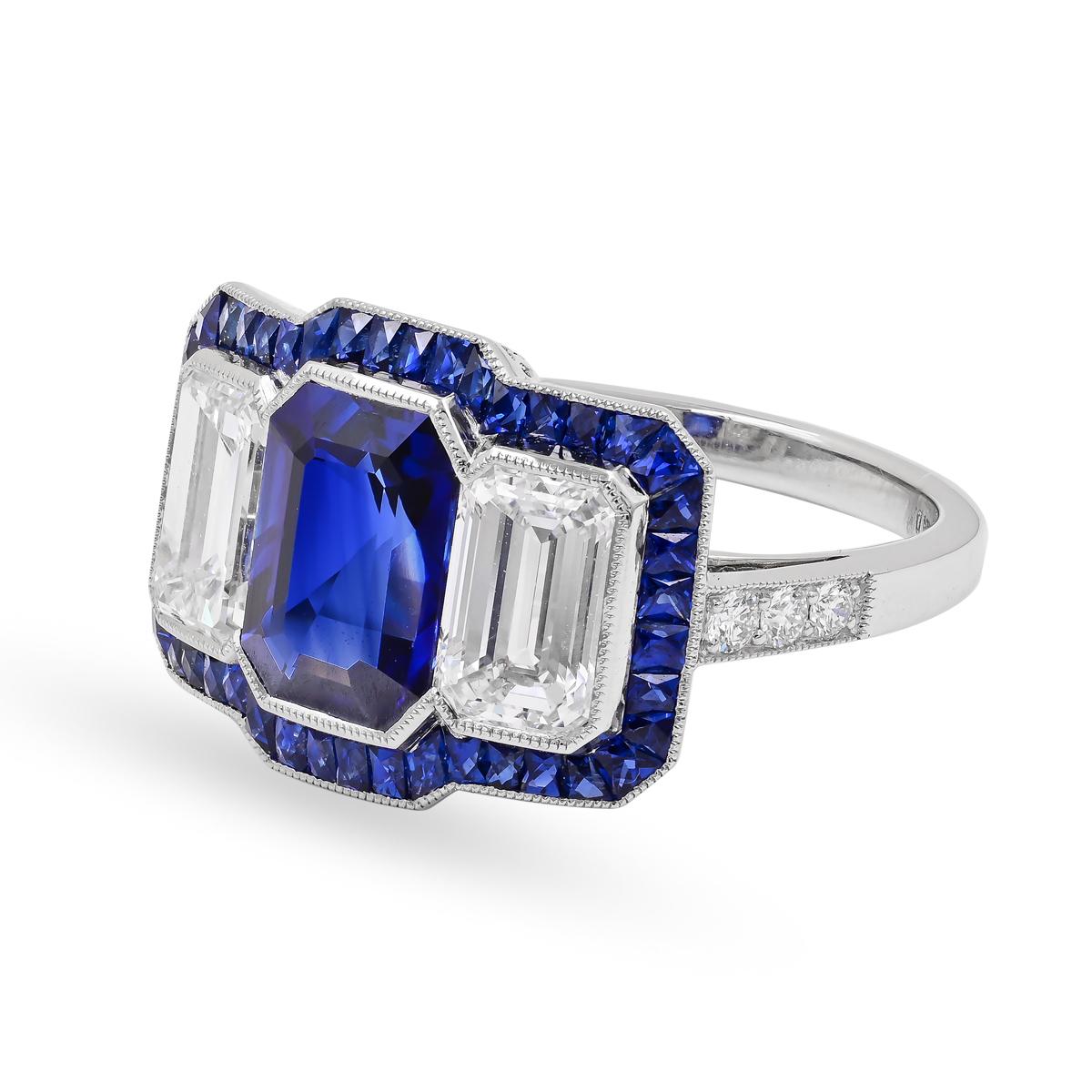 A one of a kind Sophia D art deco style three-stone ring featuring emerald cut diamonds and emerald cut blue sapphire surrounded with french cut blue sapphire and round diamonds set in platinum.

Total center diamond weight: 1.82 carats
Total center