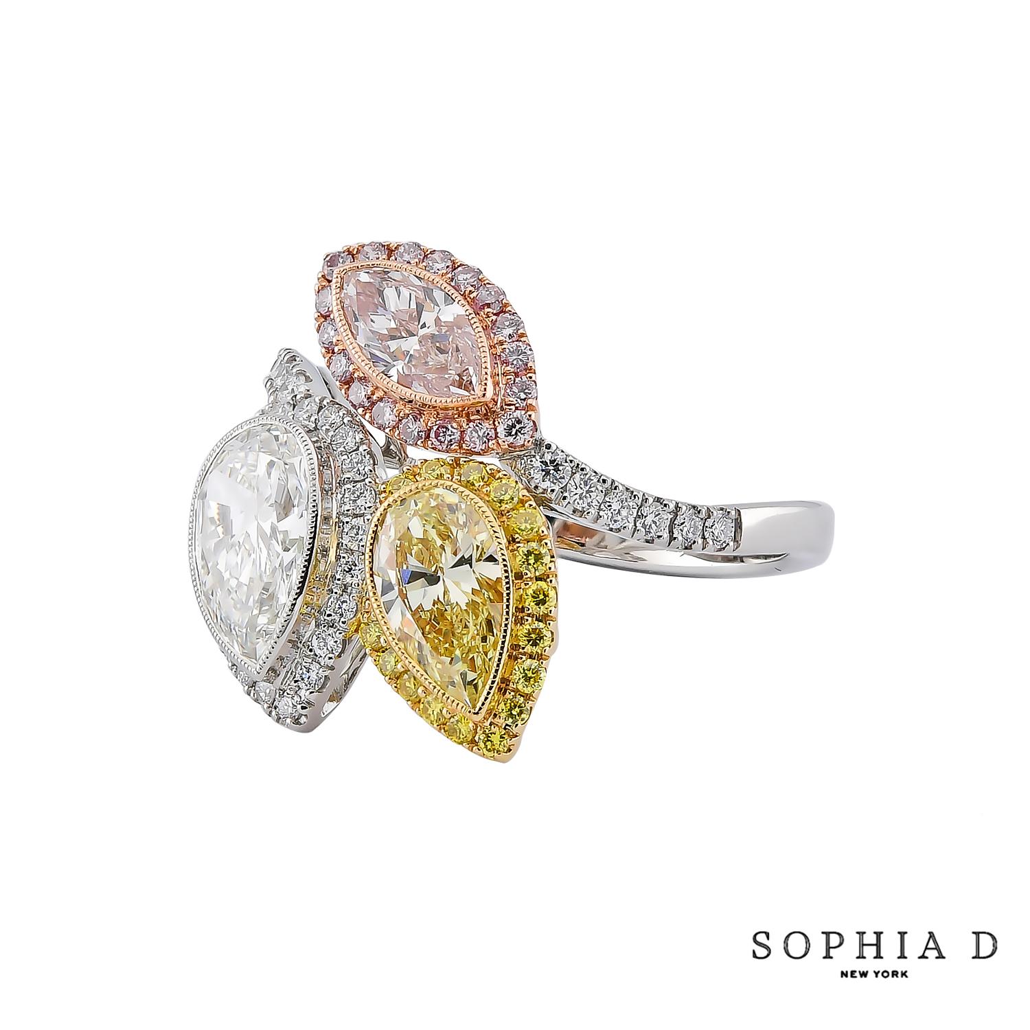 The Sophia D Toi et Moi ring is a striking combination of color and brilliance. It showcases a 1.06-carat white diamond at the center, complemented by a 0.70-carat pear-shaped yellow diamond and a 0.46-carat marquise-cut pink diamond. With