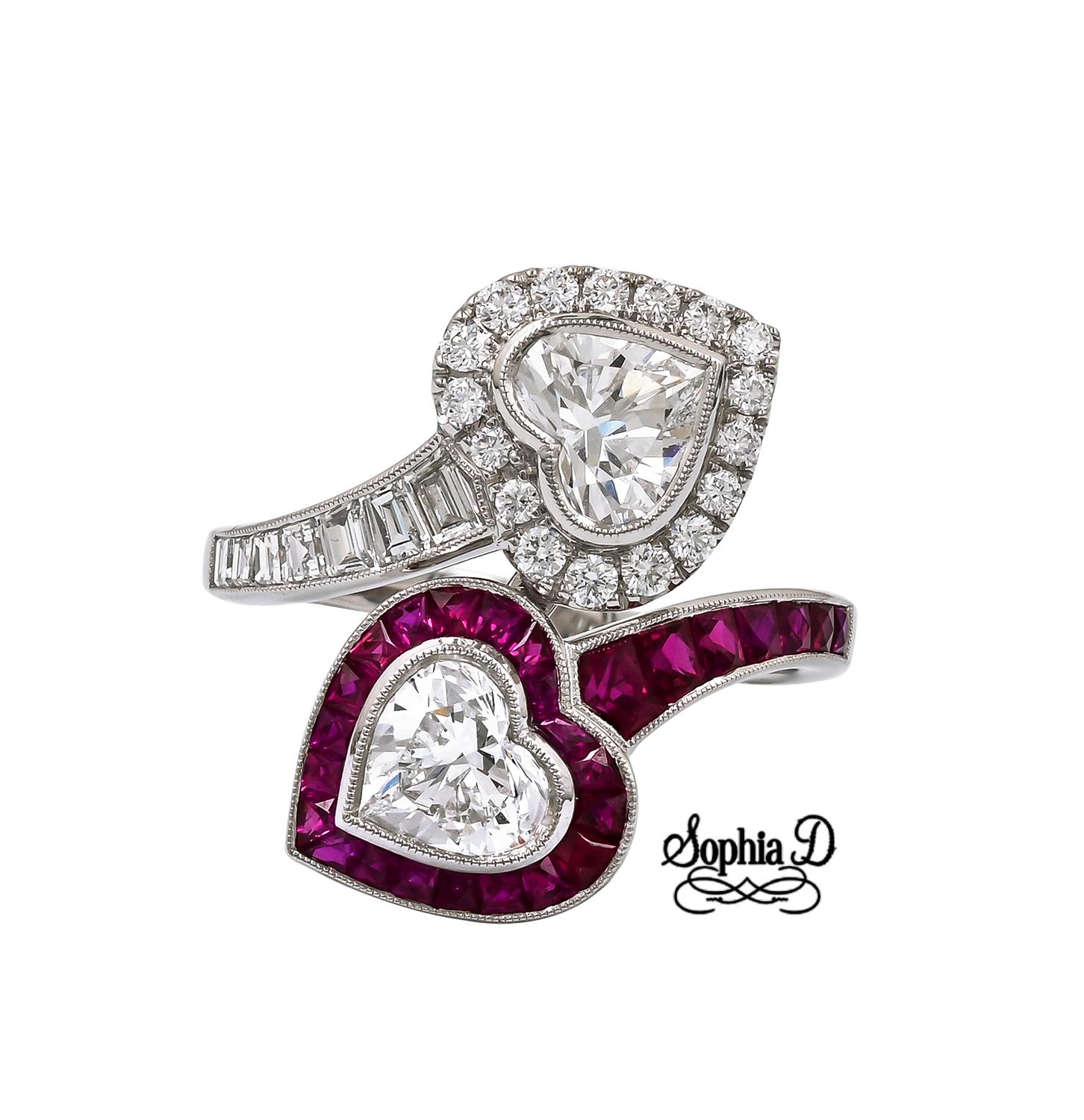 A timeless symbol of love and connection, this heart shaped Toi et Moi ring set in platinum features 2 heart shaped cut diamonds that weigh .81 ct and .78 ct surrounded with .19 ct diamonds and .85 ct rubies.

Sophia D by Joseph Dardashti LTD has
