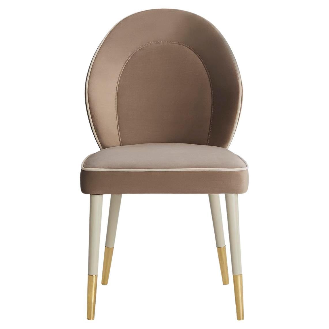 Elegant and comfortable, SOPHIA is a chair with a special quilted details on the back.‎ Perfect from every angle, this chair is upholstered in fabric, while the lacquered legs are enriched by antique brass tips. Sophia is also available in leather,