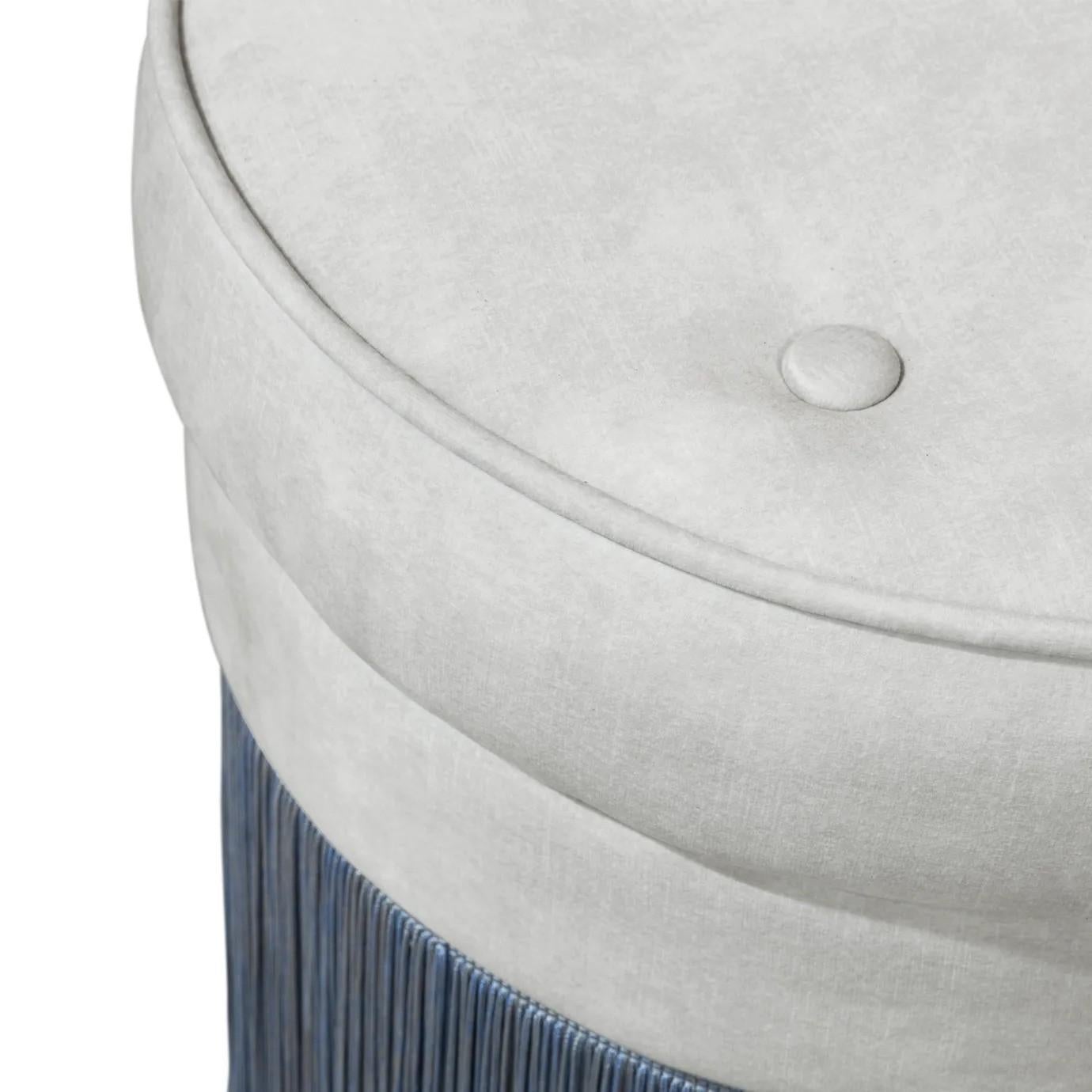 Each of these fashionable pouf stools feature their own unique combination of contrasting materials. One of a trio of KOKET pouf designs, the tailored button tufted seats, satin brass belts and flowing fringed skirts make this lovely lady the