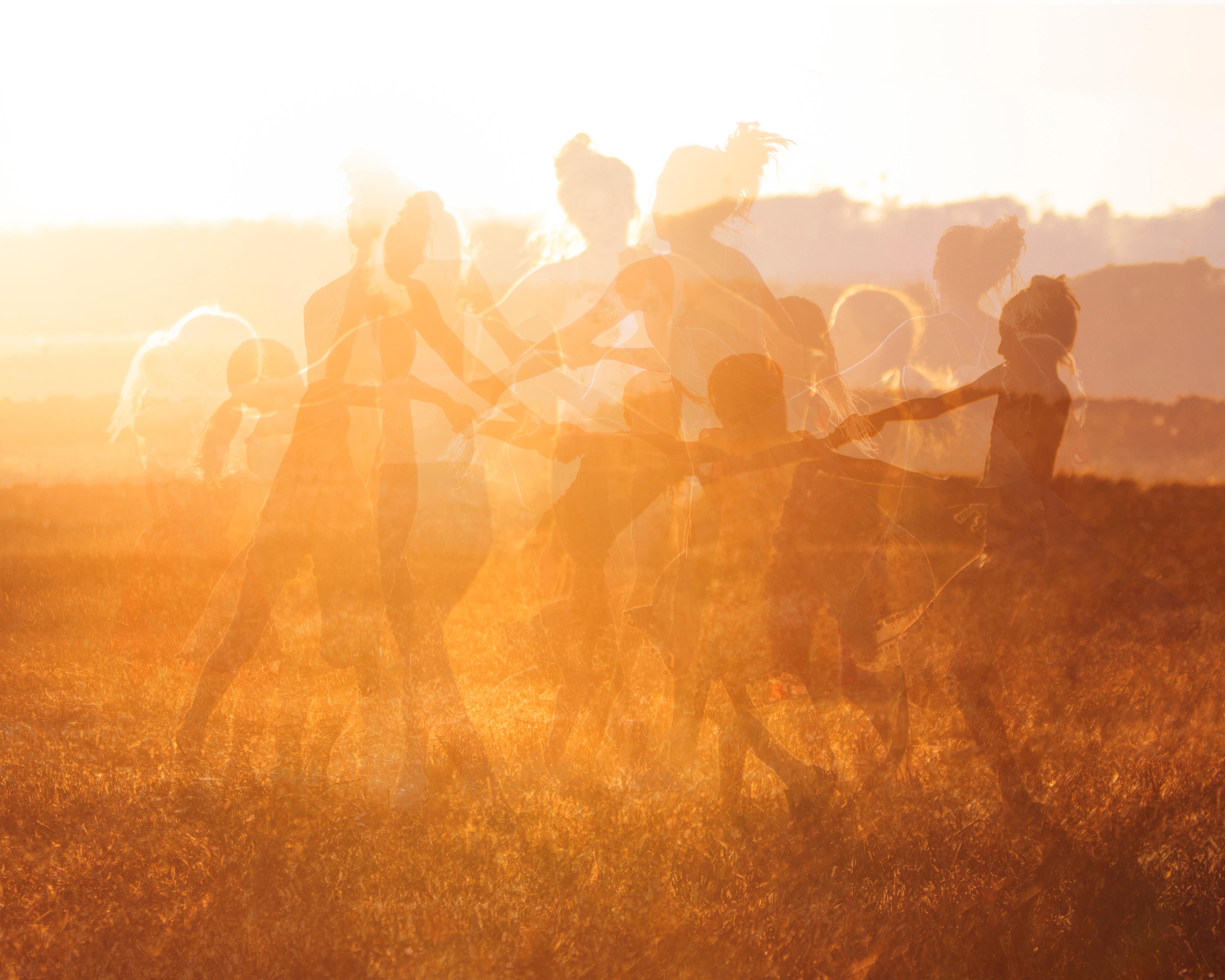 Sophia Milligan Figurative Photograph - 'Harvest Dance' Movement dance figures gold yellow orange fire nature wild 