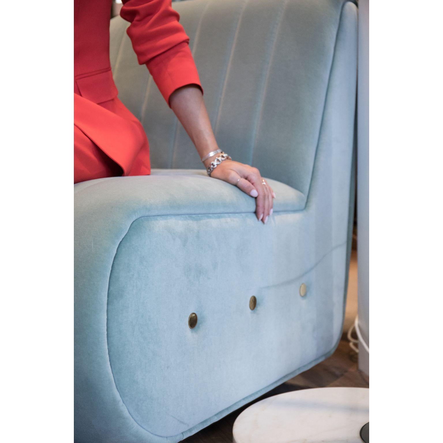 Sophia is a particular bench seat sofa that draws inspiration from the aesthetics of Mid-century Modern Design. It is upholstered in velvet and stitched from the top to the bottom. The base is made of gold plated brass and it has button tufted