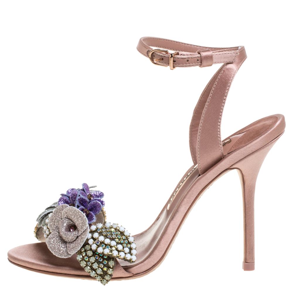 These sandals from Sophia Webster are just right on trend! They are crafted from beige satin and designed with buckled ankle fastenings and glitter flower appliques on the uppers. This eye-catching pair is sure to have everyone in admiration.

