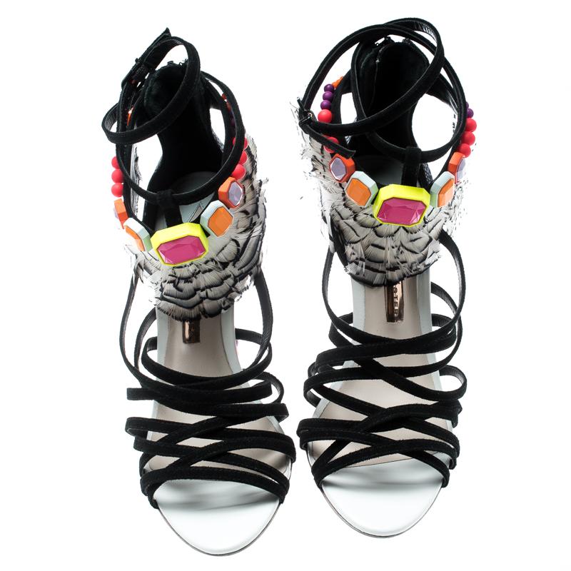 Beauty comes alive in these amazing Alessandra sandals from Sophia Webster. They feature black suede strappy front along with intriguing pheasant feather trims near the ankle straps that are also adorned with multicolored studs. Complete with