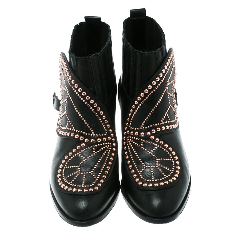 This unique pair of leather boots is all you need to bring out your creativity to your next outing. Crafted from leather, the boots feature stud detailing in the pattern of a butterfly and block heels for a slight lift.

Includes: Original Dustbag,