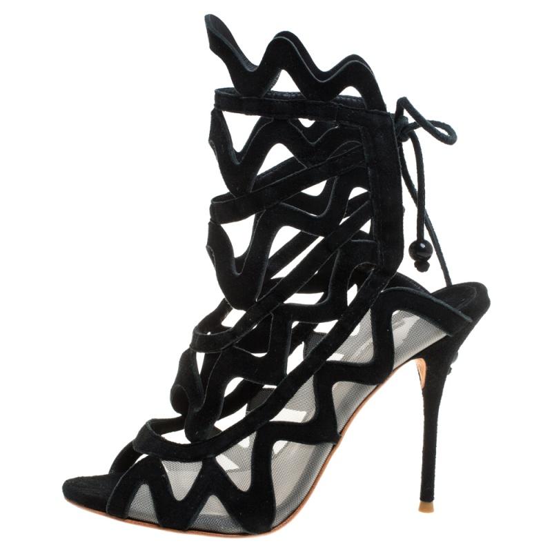Sophia Webster presents to you these black sandals that will envelop your feet in style. They have been crafted from suede and mesh into an open toe cage-like silhouette with tie-up fastenings at the back. They are equipped with comfortable insoles