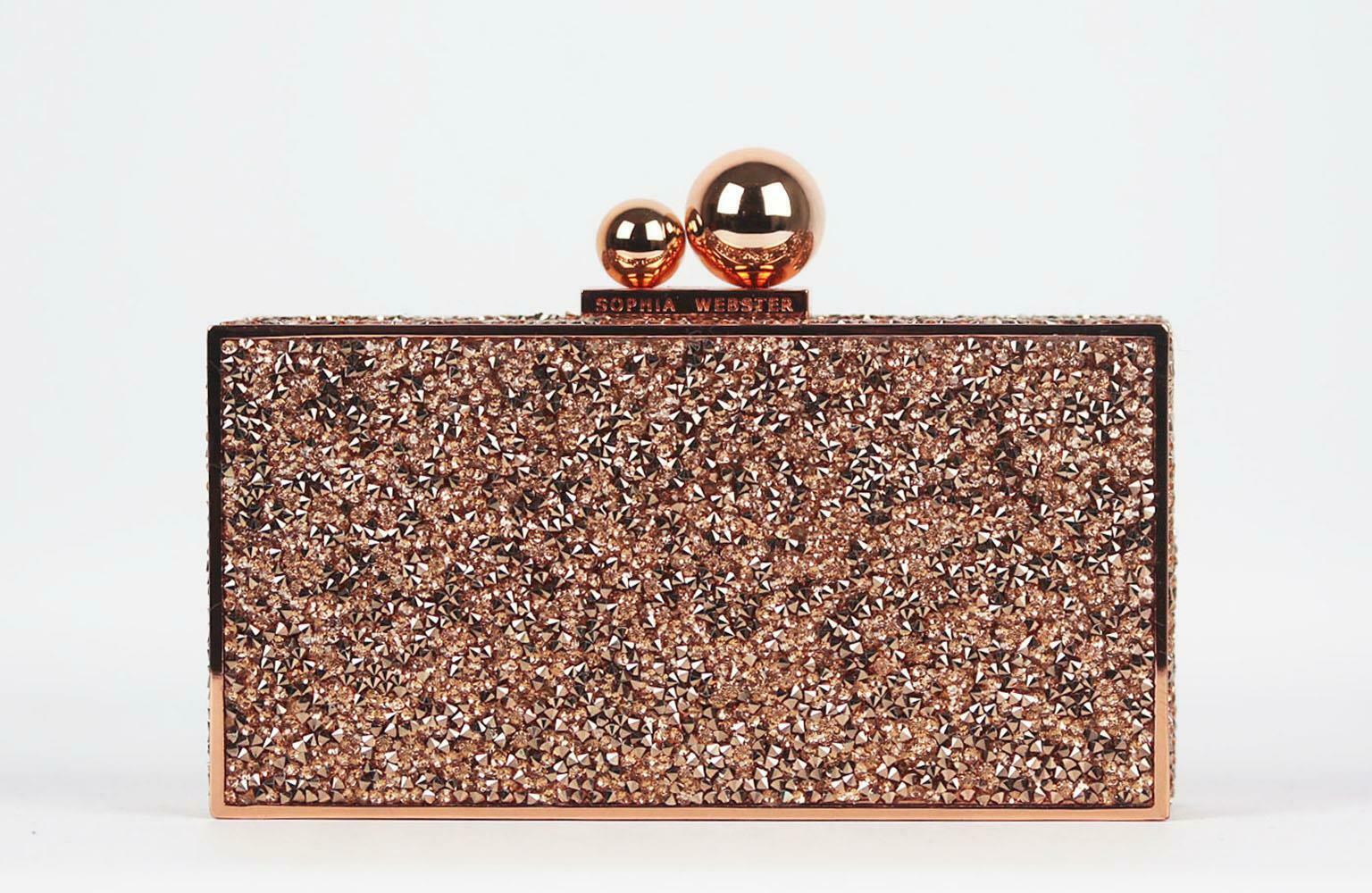 The glittering crystals embellishing Sophia Webster's 'Clara' clutch are perfectly in-tune with the label's femininity, the structured shape is crafted with a rose-gold metal frame that opens via a logo-engraved magnetic clasp to reveal a pink