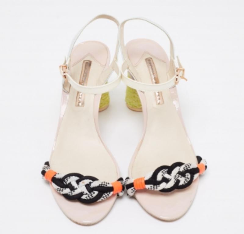 The beautifully designed heels of these Sophia Webster sandals serve as their striking element. Created from leather, patent leather, and knit fabrics, they are styled with an interwoven strap on the vamps, an ankle buckle closure, and gold-tone