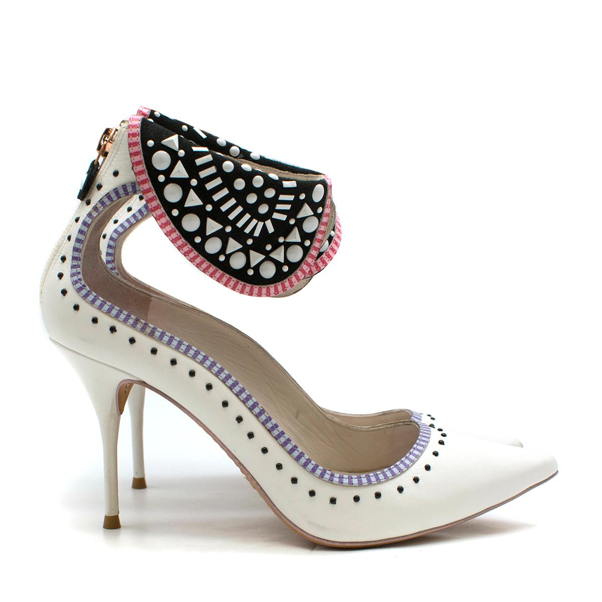 Sophia Webster White Leather Studs Embellished Collar Pumps

- White leather pumps
- Stiletto heel
- Purple and blue trim embellished with black crystals
- Embellished with black studded suede collar with pink trim 

This item comes with the