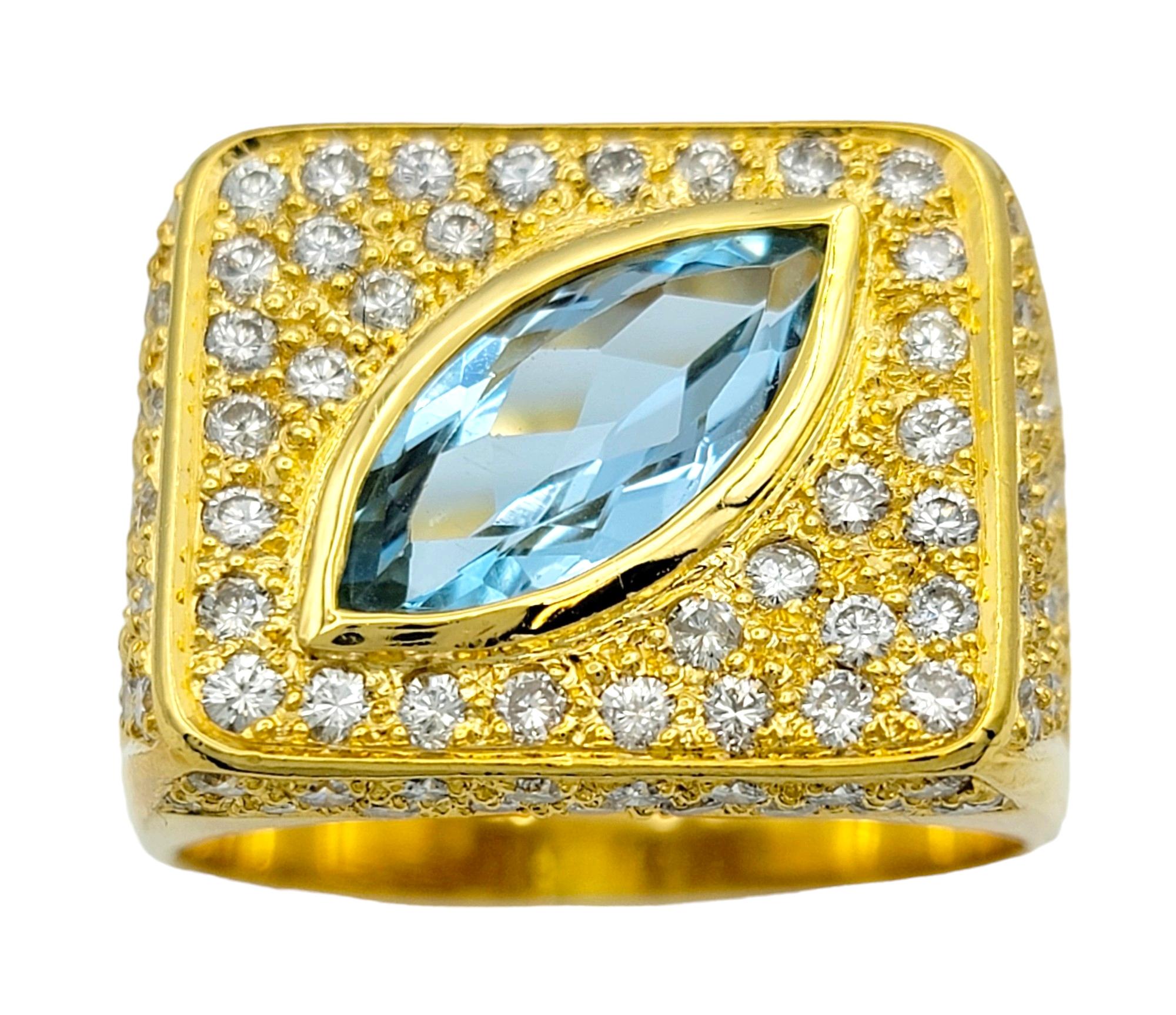 Ring size: 12.75

Make a bold statement with this striking 18 karat yellow gold squared cocktail ring designed by Sophie d'Agon. At its core lies a captivating marquise-cut aquamarine stone, bezel-set on a diagonal for a modern twist on classic