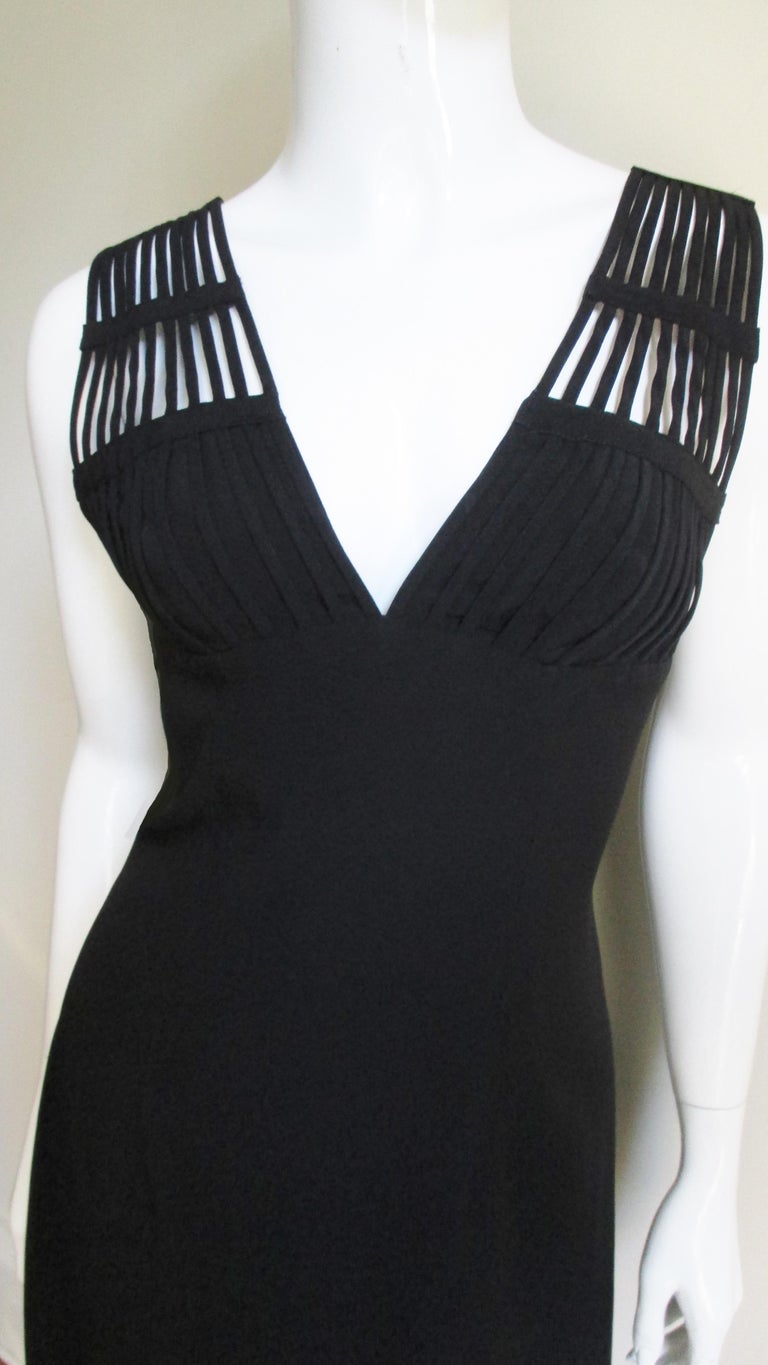 A pretty black dress from Sophie Sitbon.  It is simple semi fitted with a V neckline with small straps from above the bust line that form shoulder straps then splay out in the dress back. It is fully lined and has a center back zipper.
Fits sizes