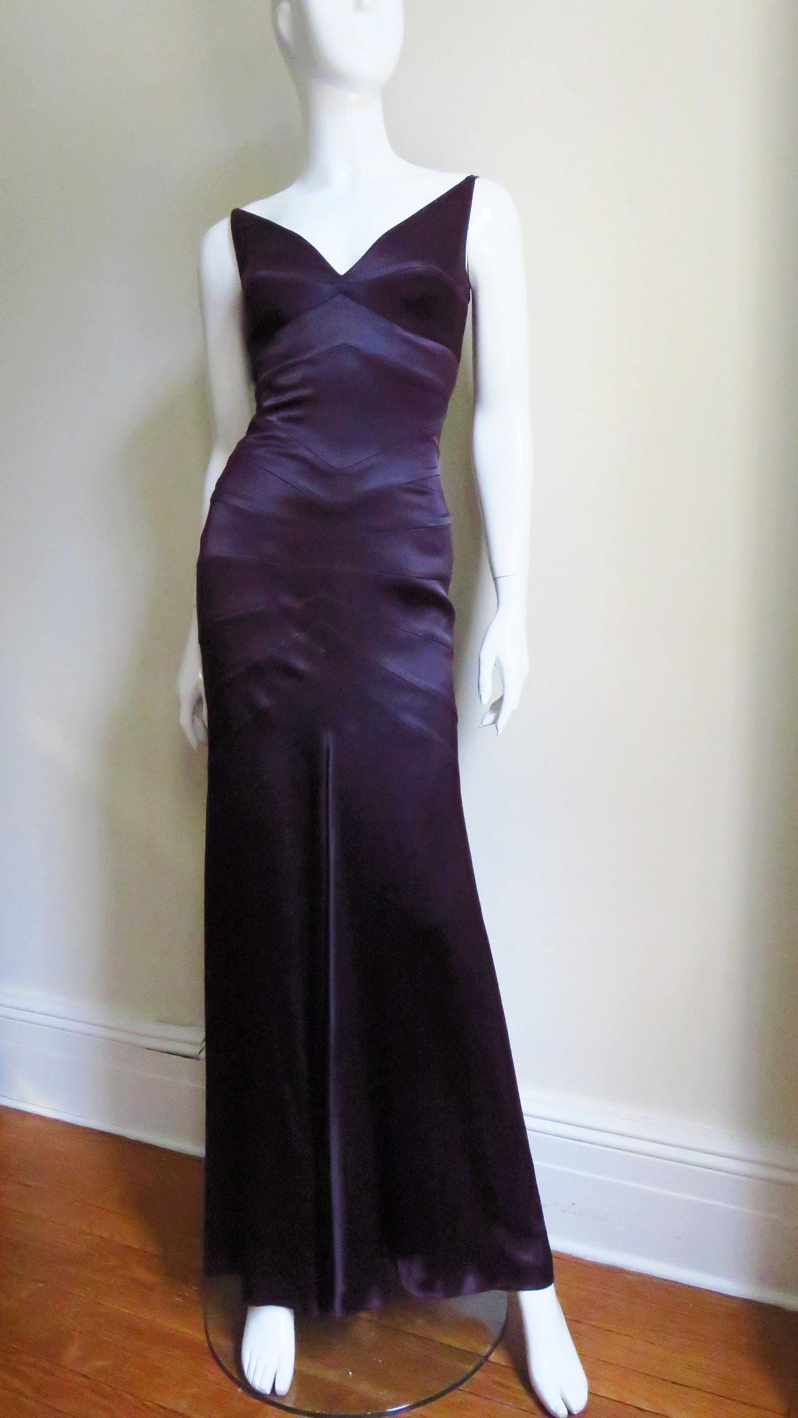 A stunning dress in rich eggplant purple silk from French designer Sophie Sitbon. Very flattering with horizontal panels through to the thighs drawing in the waist and enhancing the derriere with the skirt flaring to the hem with extra fullness at