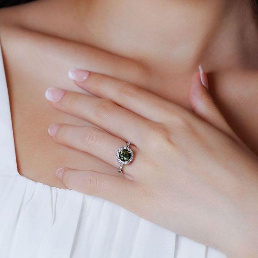 Dieser Ring ist mehr als nur ein Schmuckstück; er ist ein Gesprächsanlass. Der bezaubernde grüne Saphir ist der Star der Show, während die funkelnden Diamanten ihn wunderschön einrahmen. Sein zartes Design und sein angenehmes Gewicht machen ihn