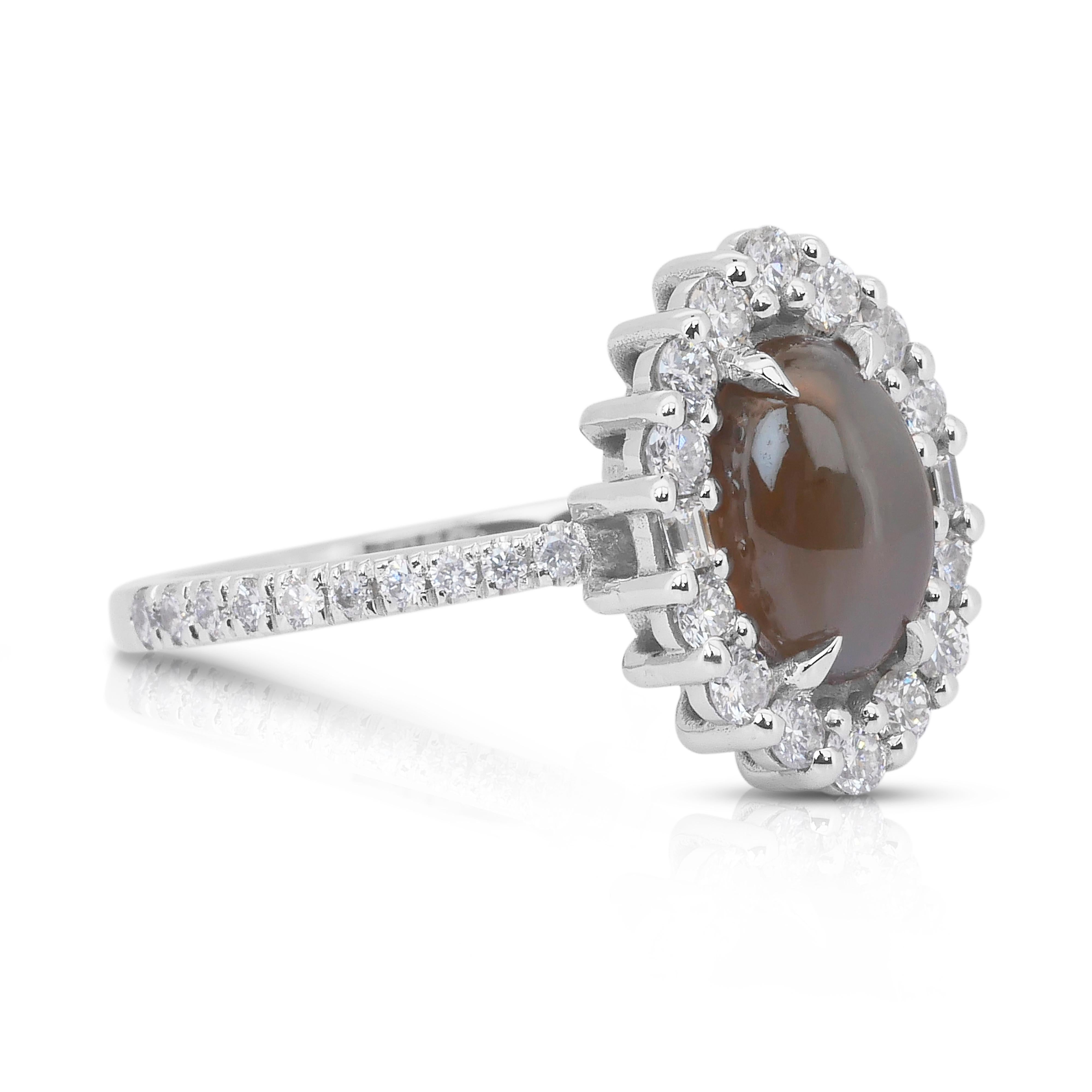 Sophisticated 2.77ct Cat's-Eye Chrysoberyl and Diamonds Cluster Ring in 14k White Gold - IGI Certified

This 14K white gold ring showcases a captivating 2.21ct oval Cat’s Eye Chrysoberyl, glowing with a rare yellowish-green hue. Its mystical