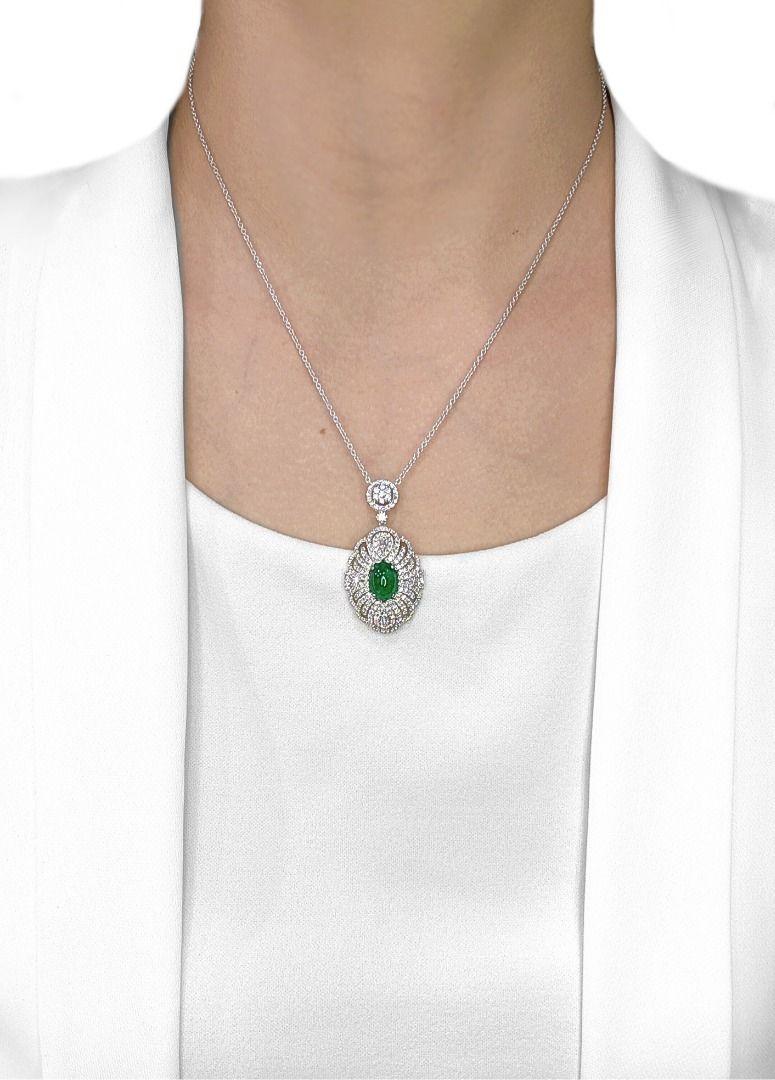 This exquisite necklace captures timeless elegance with a 2.65ct cushion-cut emerald at its center, glowing in a rich green hue that radiates sophistication. Surrounding the emerald are 200 natural diamonds—196 round brilliant and 4 tapered—totaling