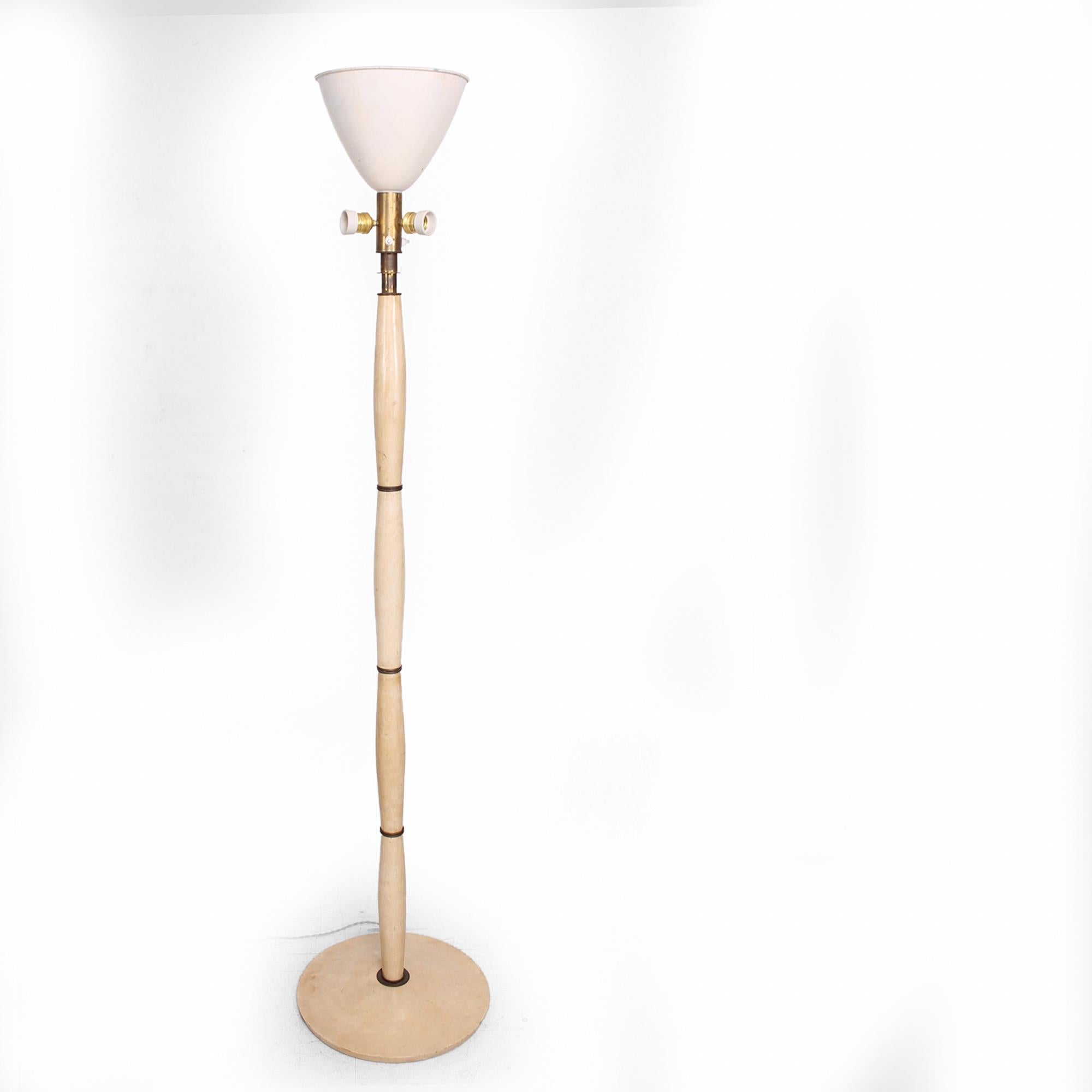 AMBIANIC presents
Aldo Tura Sophisticated Italian Wood Floor Lamp covered in Goatskin Parchment with patinated Bronze Accents Italy 1950s
Includes original aluminum shade. It has two on off switches, can be operated using one to four regular bulbs.