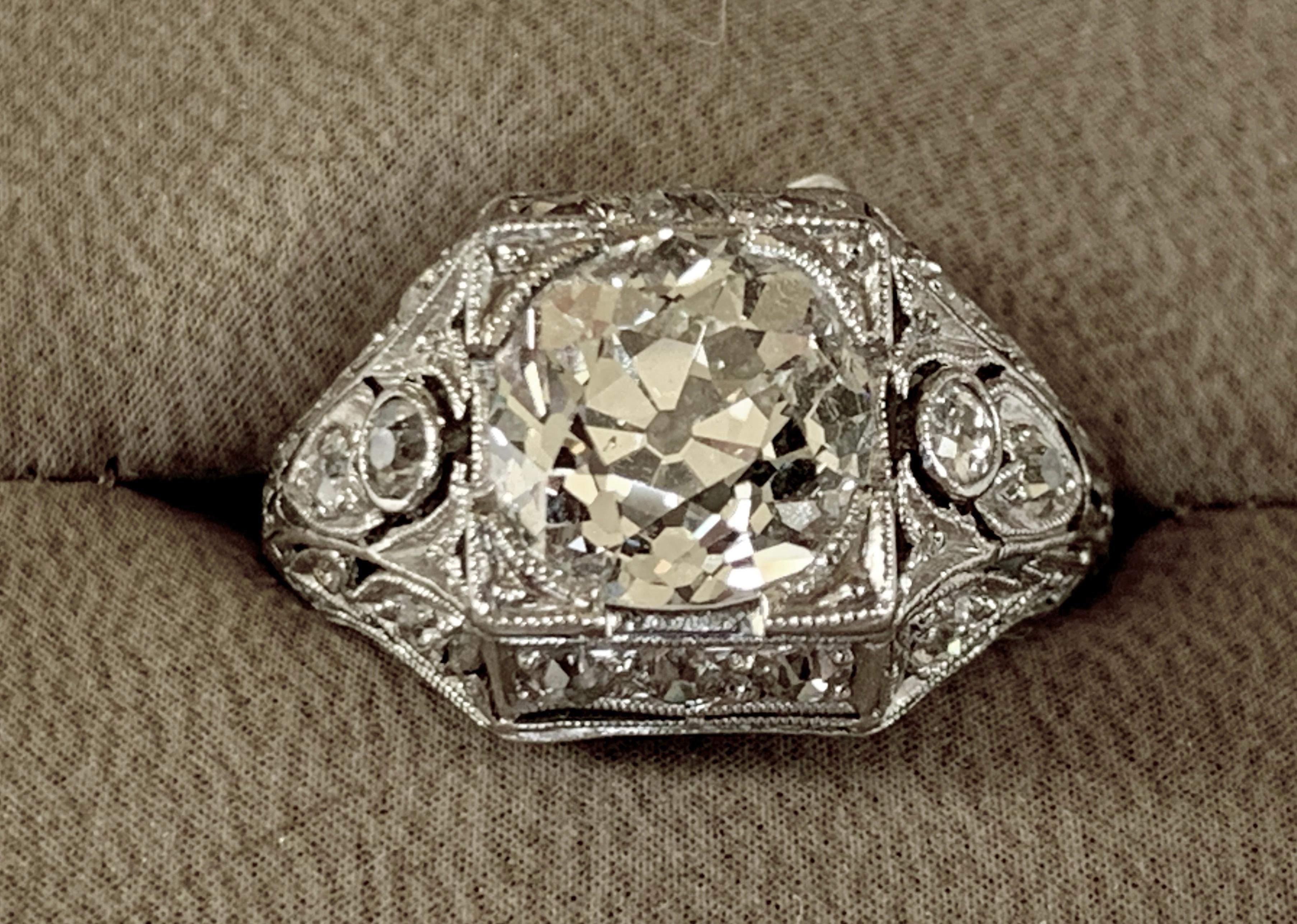 A classic Art Deco Platinum  Diamond solitaire ring comprising a transitional brilliant cut diamond of 2.53 ct., J color, si clarity  in a claw setting with unusual diamond shoulders and engraved shoulders. Size 11! Can be sized!