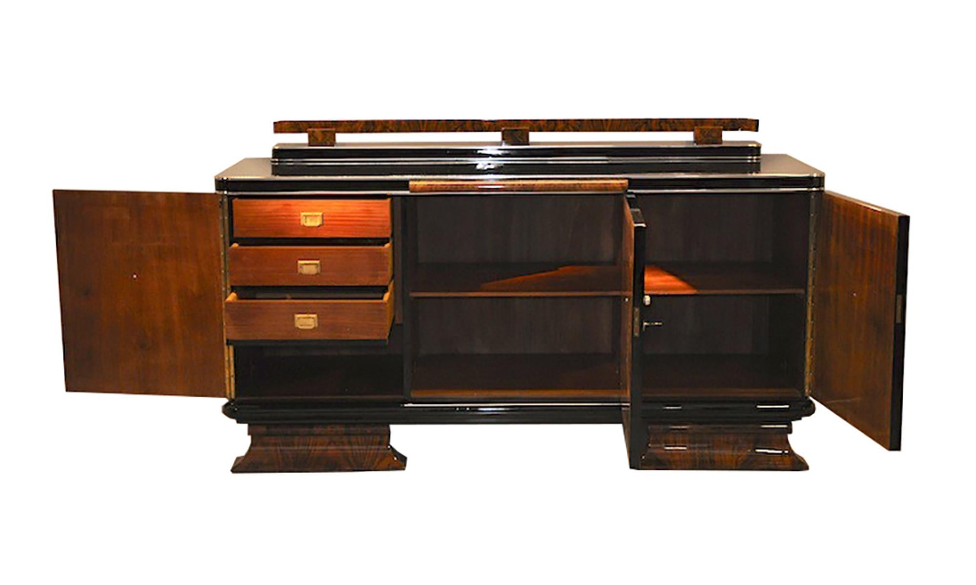 This sophisticated Art Deco sideboard features chrome hardware and detailing, and a mirrored extension plate. It has a gorgeous two-tone finish of burled walnut wood, with curved feet at the base.

 Made in France, circa 1930.