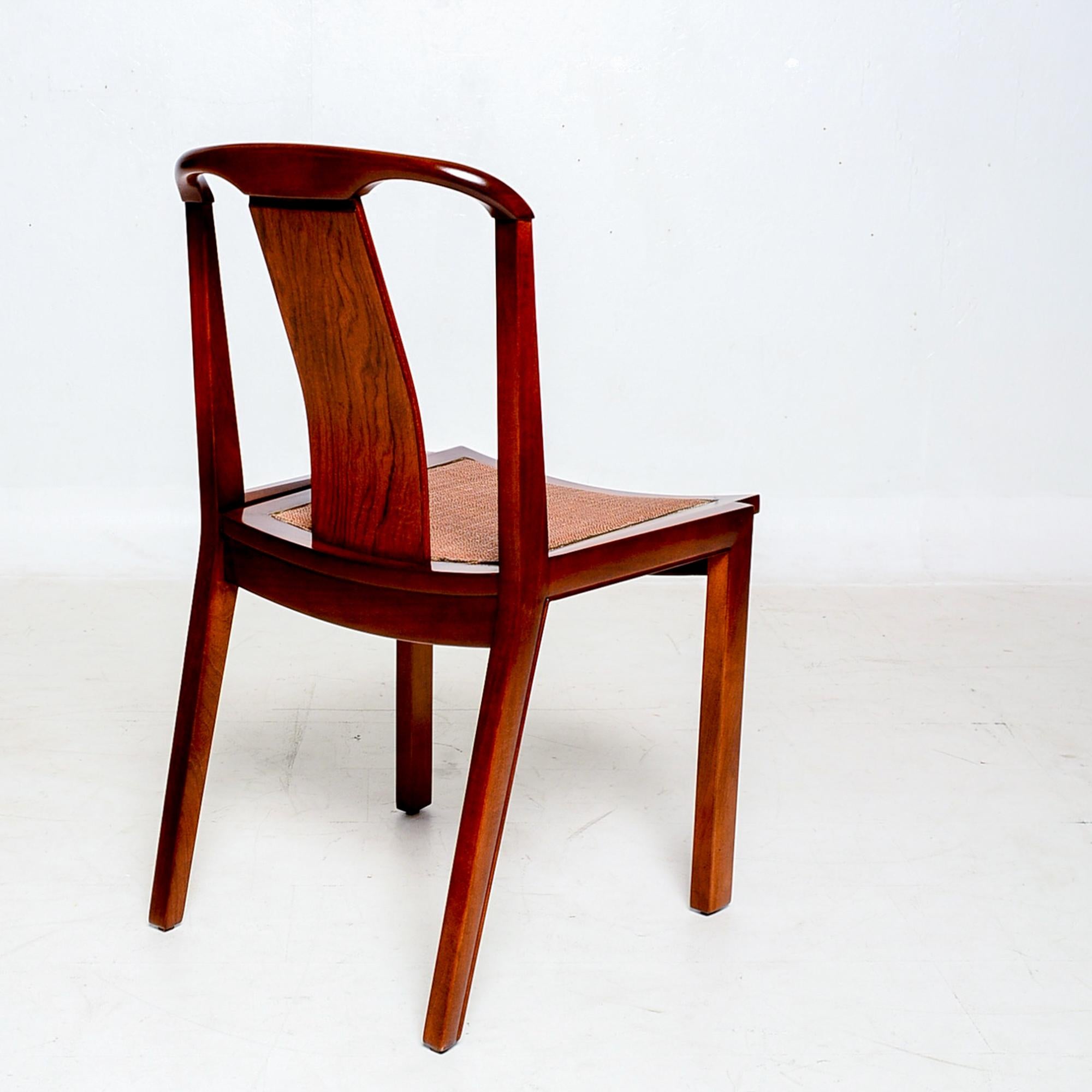 Sophisticated and elegant Baker Furniture Co Mid-Century Modern sculptural walnut wood dining chairs set of four, circa 1950s.
Attributed to the design of Michael Taylor- clean and modern lines.
No label present from the maker. Stamped with a