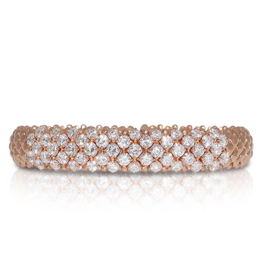 This bangle features a sleek and polished metal band, often crafted from high-quality materials such as sterling silver, white gold, or platinum. The true allure of the bangle, however, lies in the carefully selected natural diamonds that adorn its