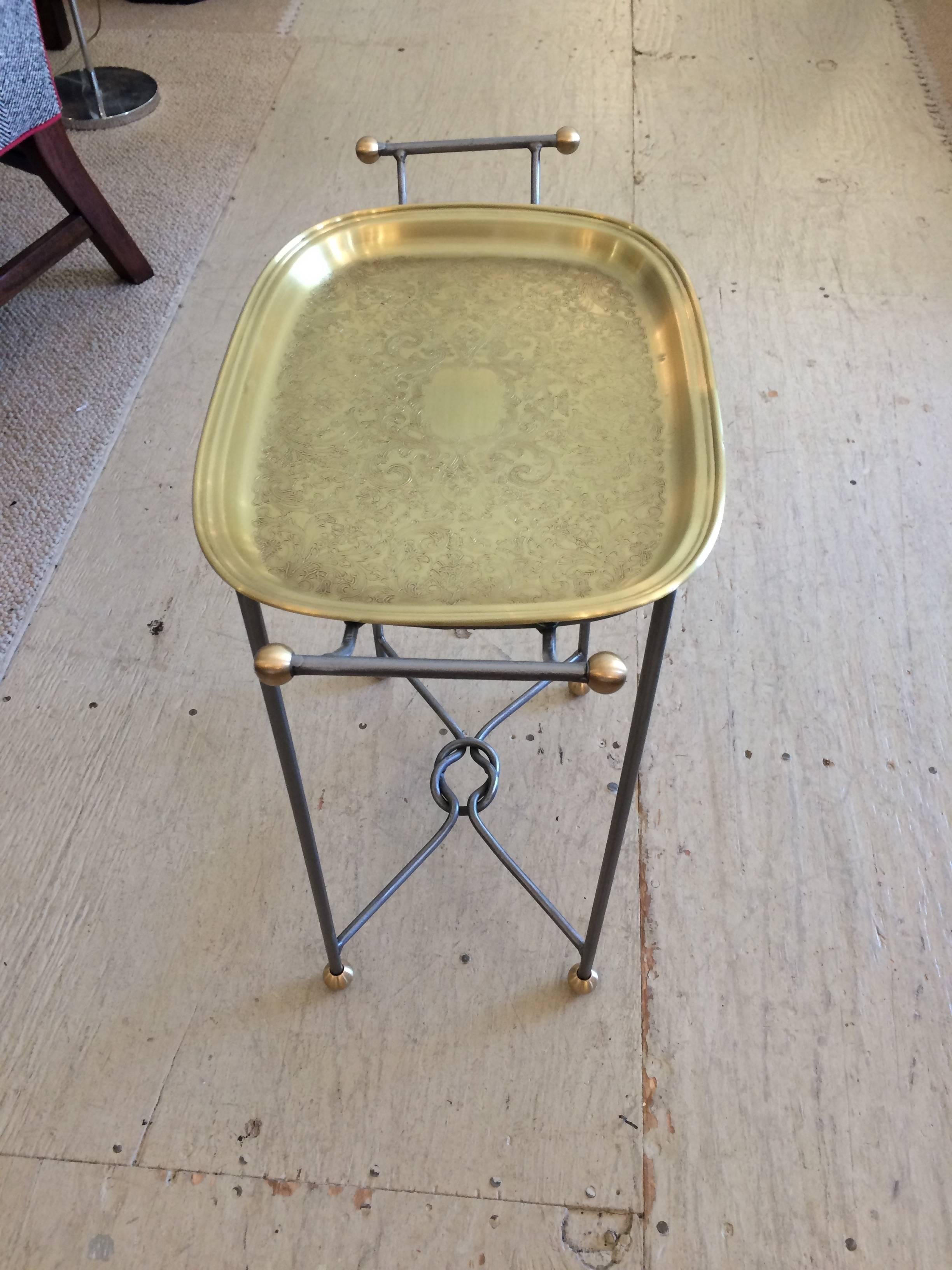 Sophisticated little “drinks” table in brass. Brass tray top is removable, and base is steel with brass ball feet. Brass has been lacquered for protection of surface.
