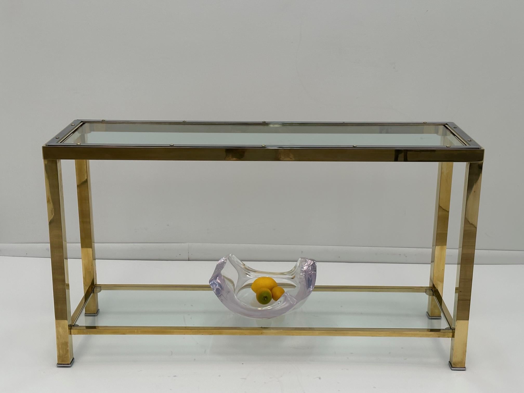 Tan France Auction Pick

Stylish sleek console attributed to Pierre Cardin having a sophisticated and versatile mix of brass and chrome, two tiers, and brand new glass.
Lower tier is 4.5