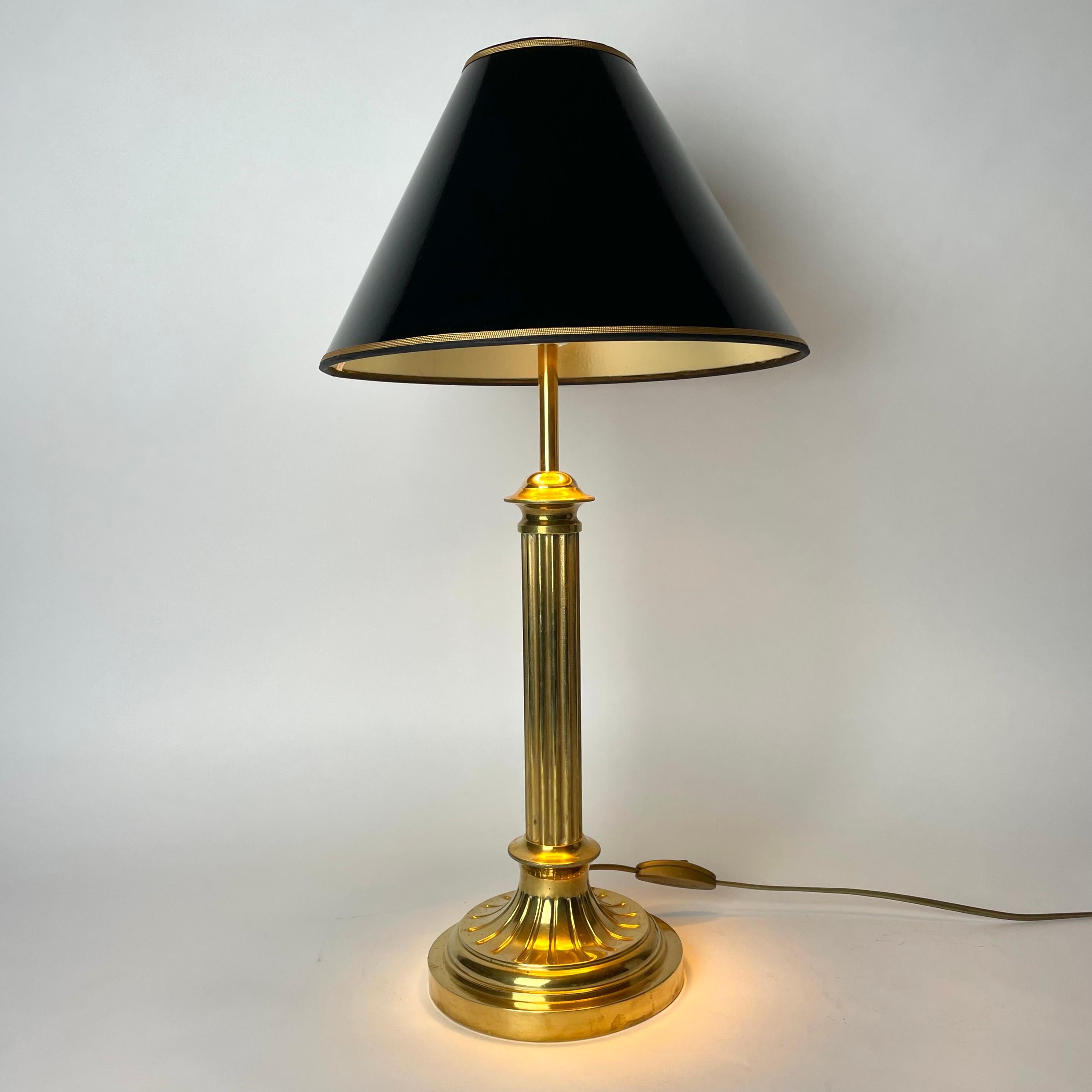 Sophisticated Brass Table Lamp with Classic column made during the late 19th Century. Originally a kerosene lamp converted to table lamp in the early 20th Century.

Newly rewired electricity 

The lampshade in black lacquer with a gilded inside to