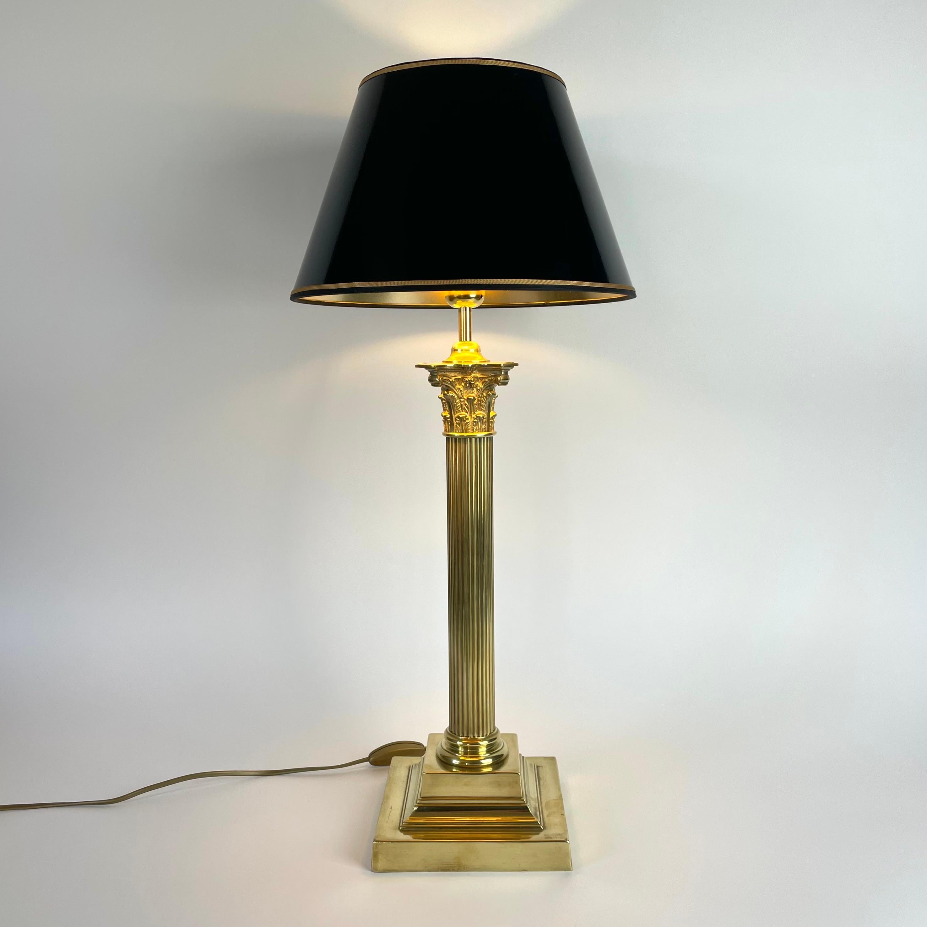Sophisticated Brass Table Lamp with Classic column made during the late 19th Century. Originally a kerosene lamp converted to table lamp in the early 20th Century.

Newly rewired electricity 

The lampshade in black lacquer with a gilded inside to