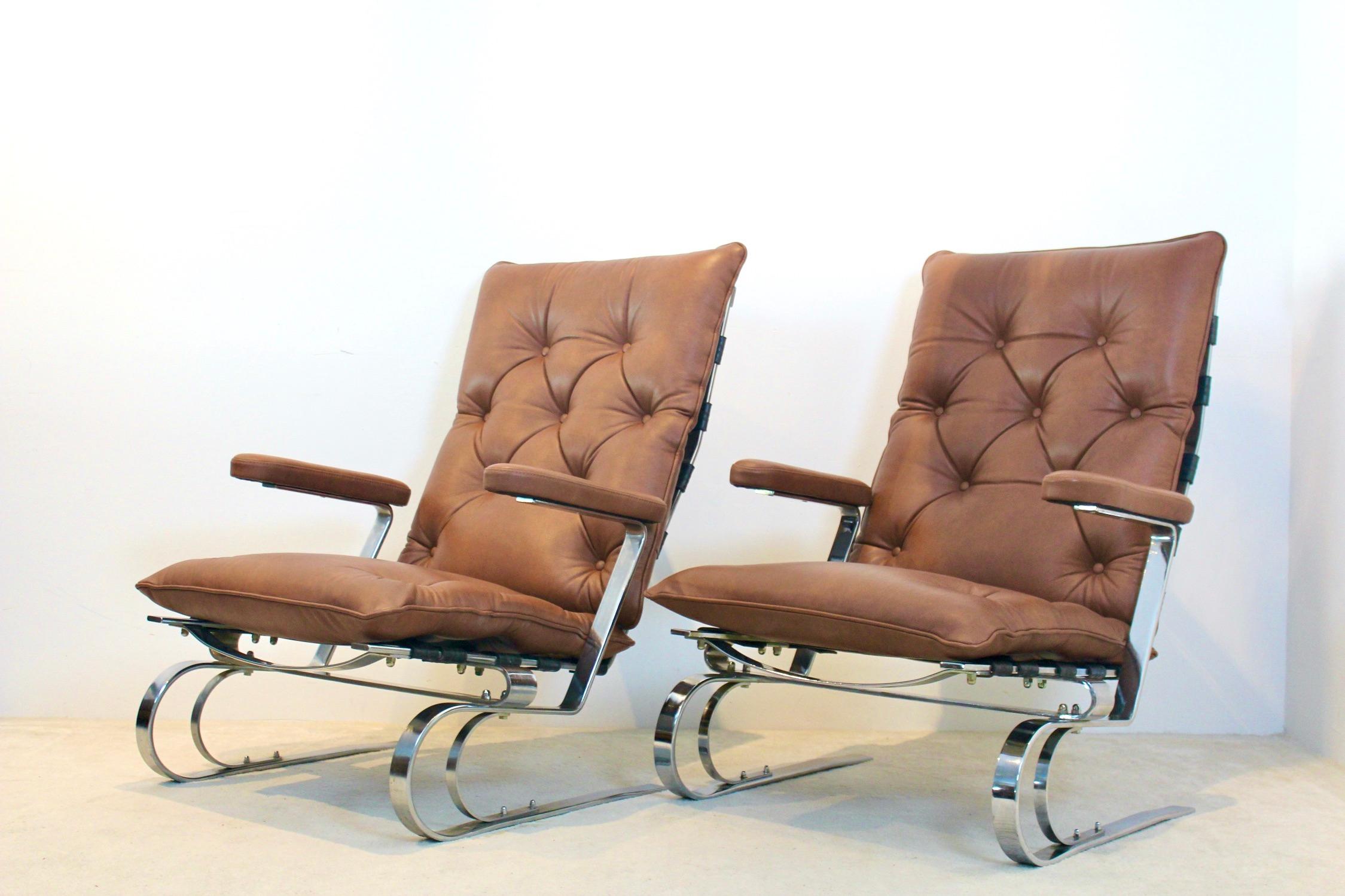 Very nice lounge chairs manufactured by COR, Germany. Extremely comfortable chairs with a solid steel chromed base, rubber straps for extra comfort and renewed high quality leather upholstery in cognac brown. Very good condition.