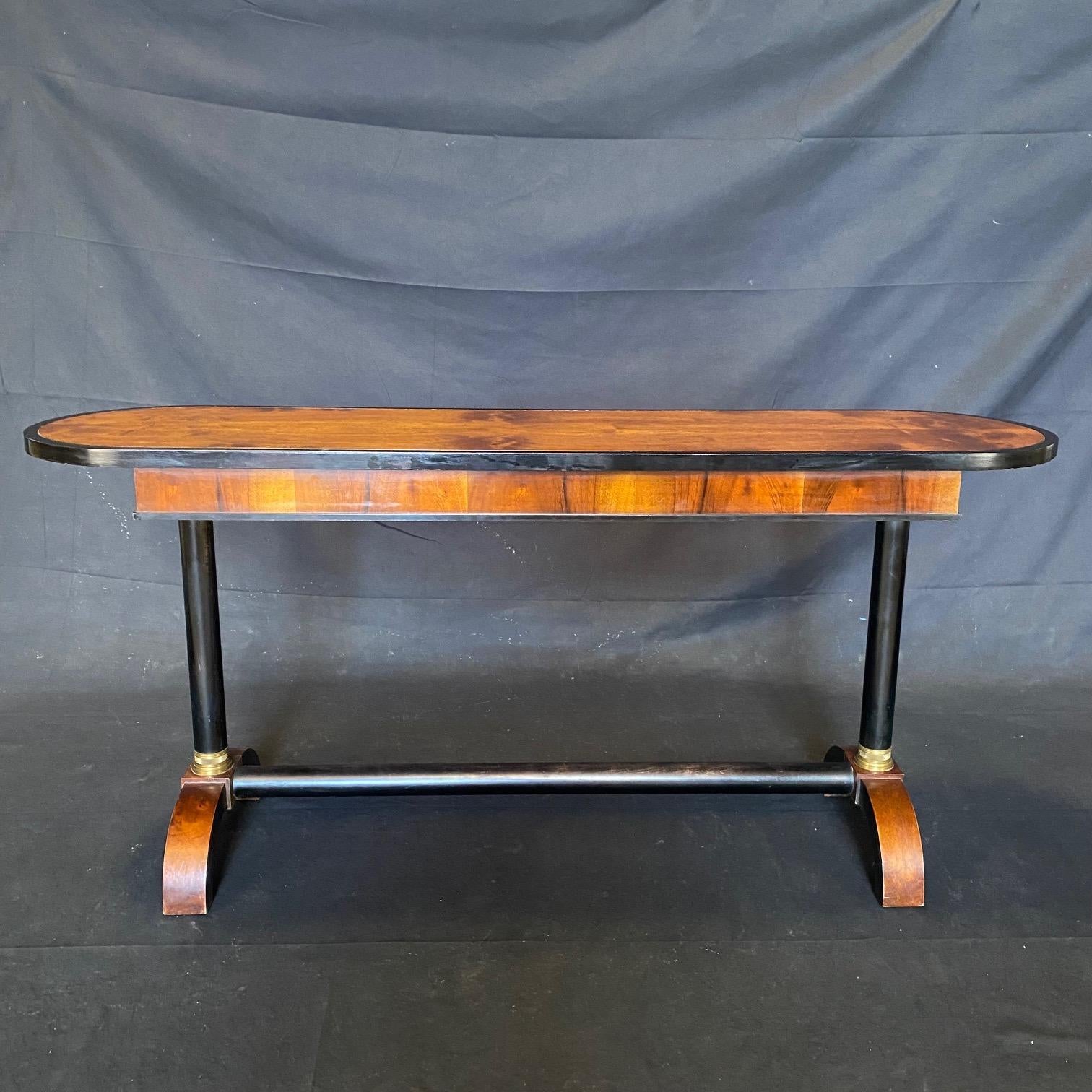 Fine French early 20th century very sophisticated walnut neoclassical console or pier table, the top having ebonized molded edge over pedestal ebony supports with bronze banding over curved legs connected with a single ebony stretcher.
 H stretcher