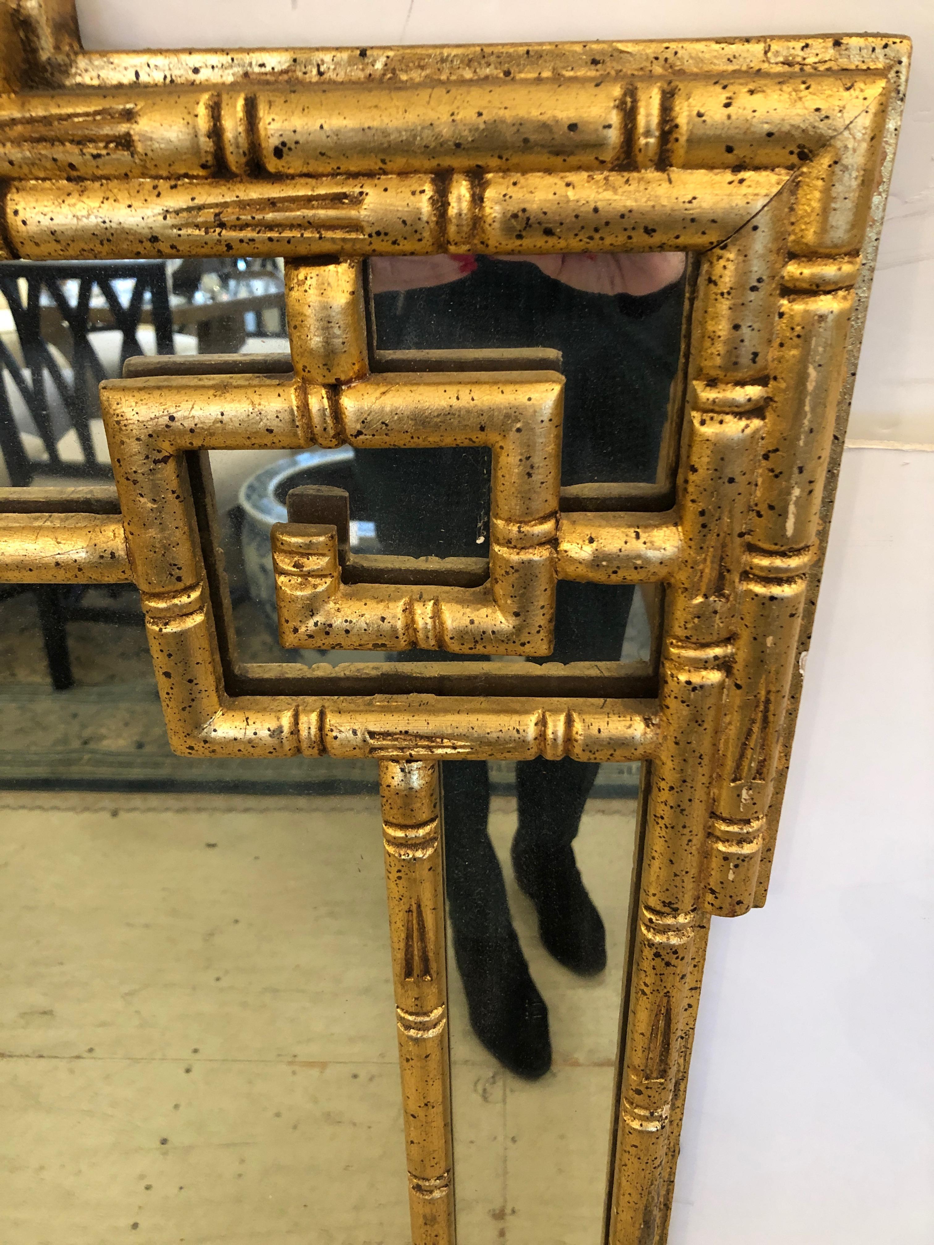 Sophisticated Italian rectangular giltwood faux bamboo mirror with Greek key motife having a vertical orientation.