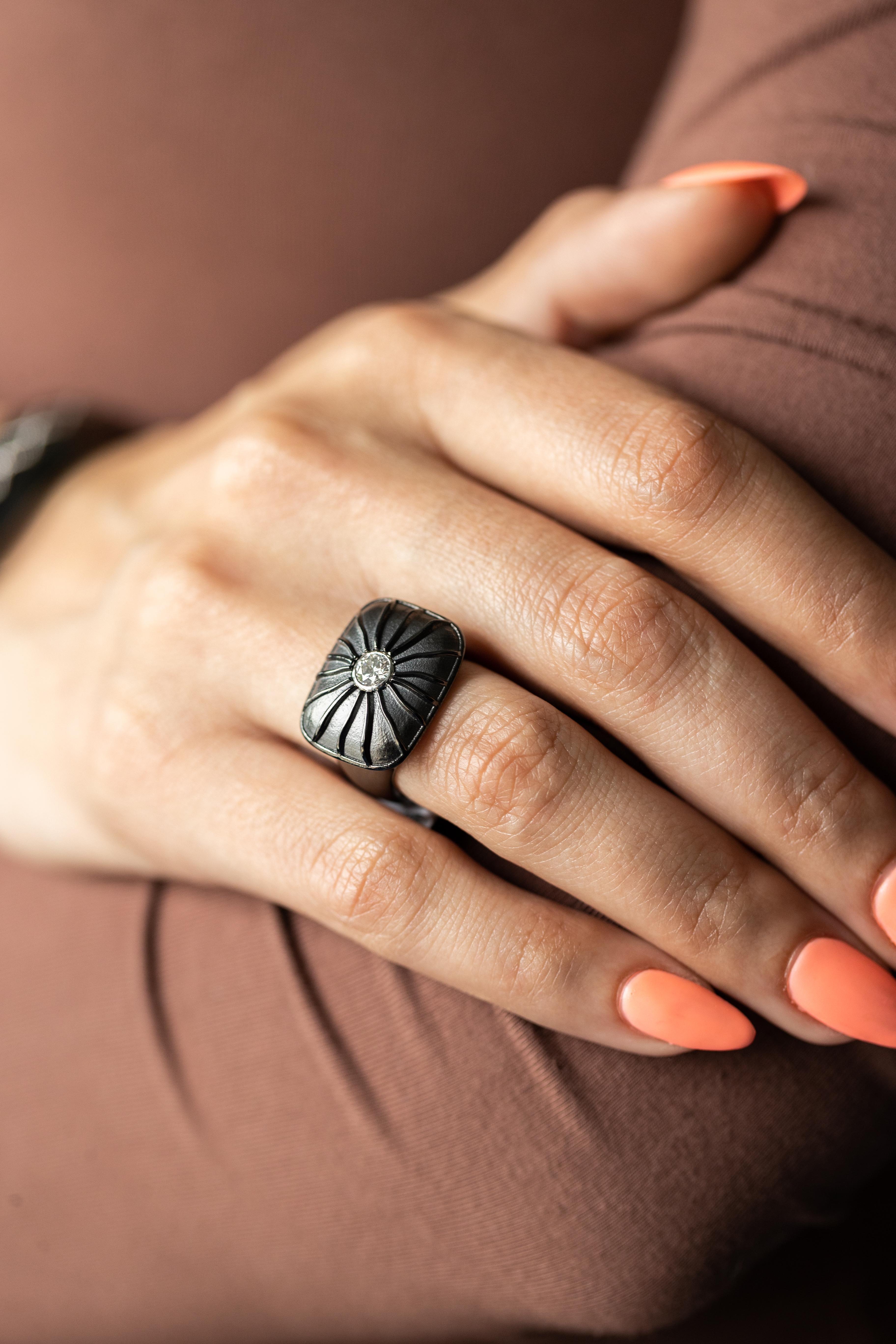 Embrace the allure of refined elegance with this stunning wide band ring, expertly crafted from Knightsteel and featuring a dazzling round brilliant cut diamond. At the heart of this exquisite piece is a 0.25-carat diamond, renowned for its
