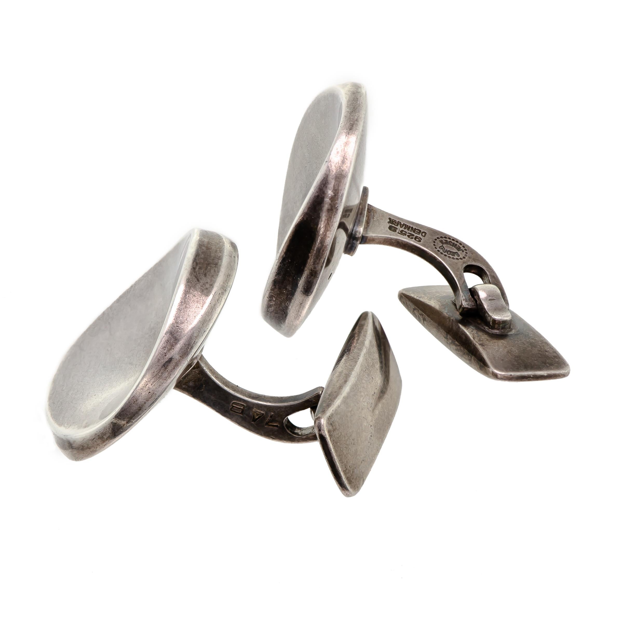 These Georg Jensen cufflinks are a stunning example of mid-century design. Made of high-quality sterling silver, they were crafted in Denmark during the 1960s and feature a unique bowed convex organic form. The dotted outline Georg Jensen, 925S