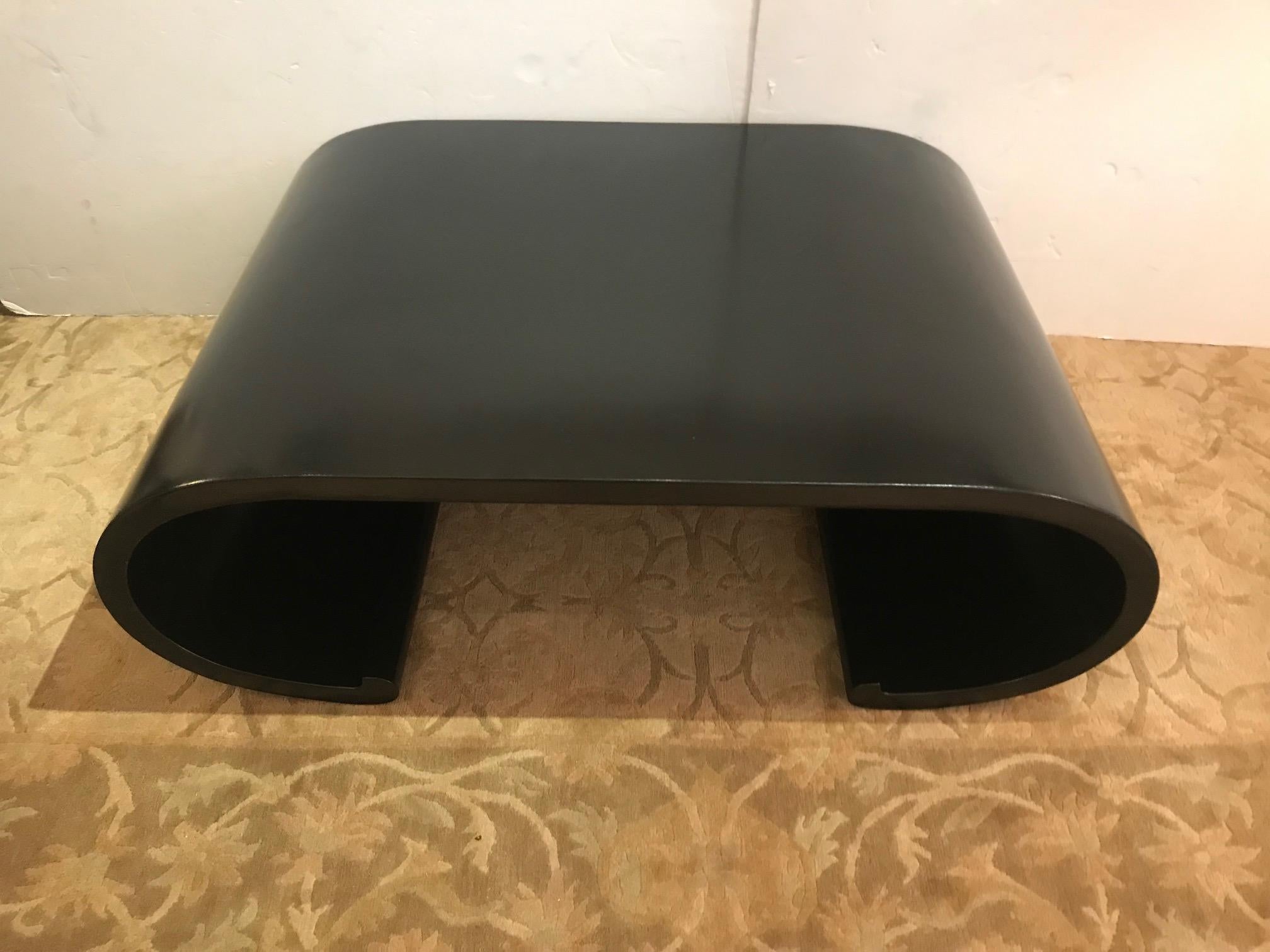 Sleek Mid-Century Modern low slung and sexy waterfall shaped coffee table, newly restored and ebonized.