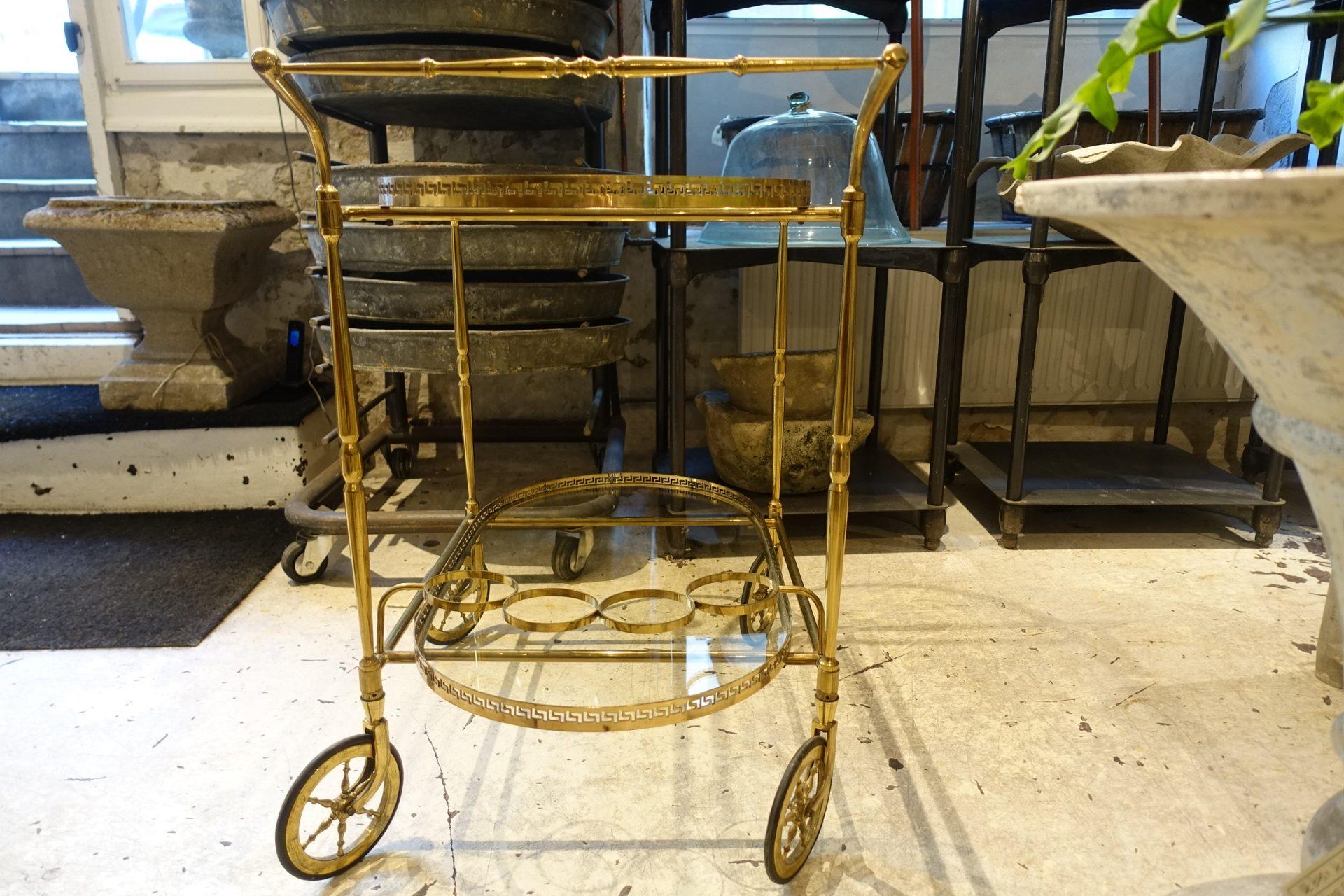 Charming French bar cart or serving trolley on wheels and with two glass shelves. Elegantly made with sophisticated brass frame. Suitable as a bar / trolley or as a lamp and side table by a chair or sofa. A lovely midcentury piece.