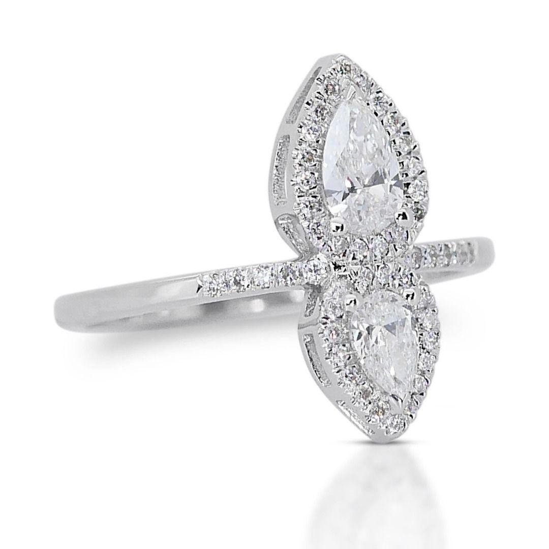 At its heart rests a dazzling 0.4 carat pear brilliant diamond, shimmering with the captivating allure of a dewdrop reflecting moonlight. The exquisite pear cut ignites a mesmerizing dance of light, showcasing a breathtaking D-E color and