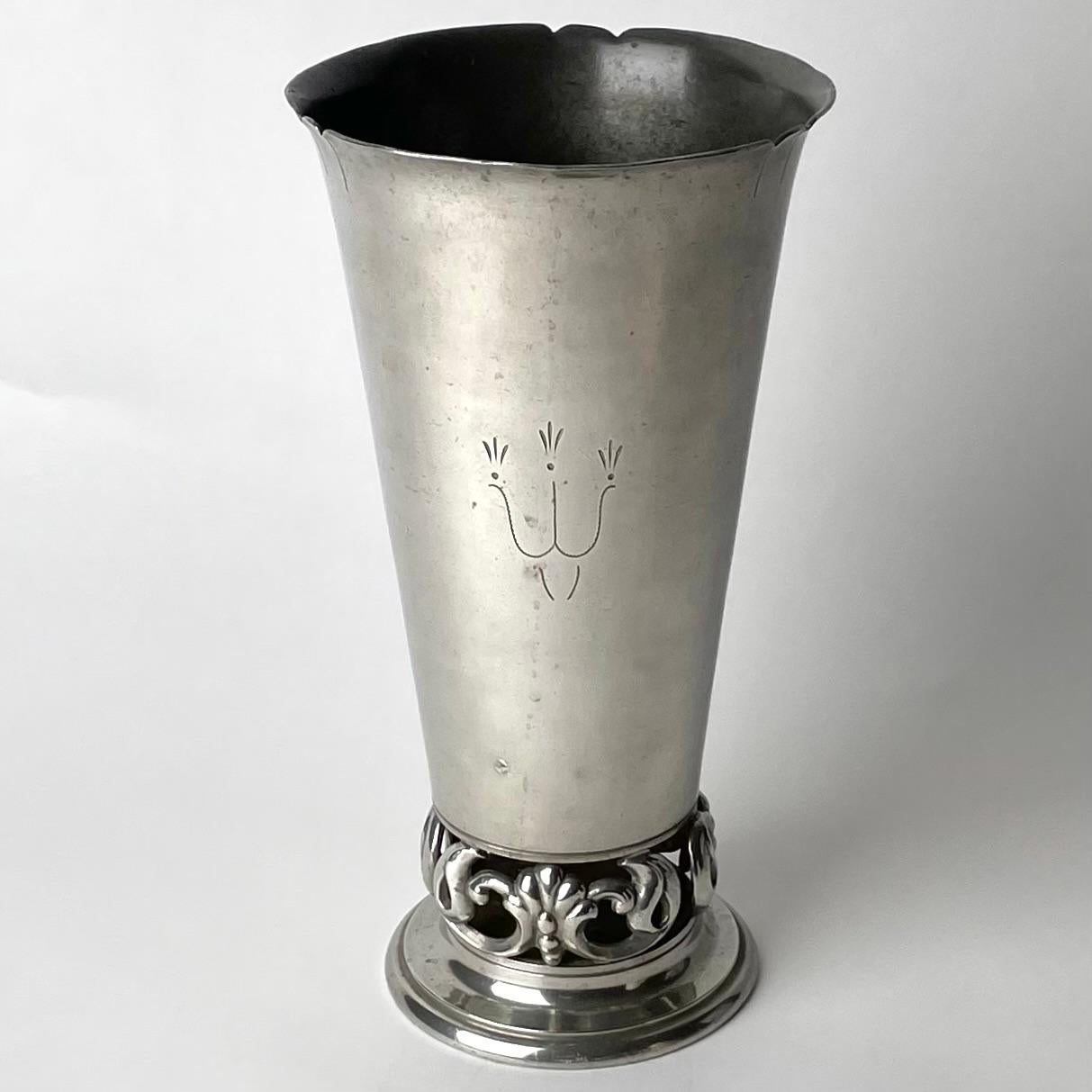 Sophisticated pewter vase in Swedish Grace. Made by J.L. Hultman in Stockholm, Sweden and dated 1932. The vase is simply and elegantly decorated on one side with an openwork decoration at the base.

Wear consistent with age and use