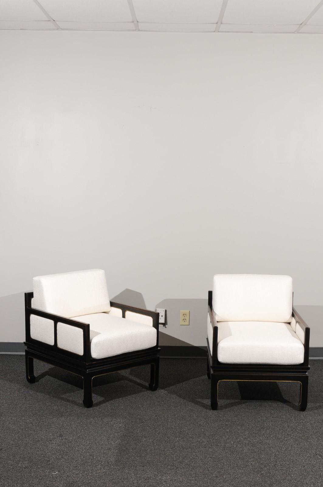 An absolutely jaw-dropping pair of meticulously restored lounge chairs from a boutique series produced by Baker Furniture, circa 1960. Extremely rare examples. Stout, expertly crafted ebonized solid mahogany construction. This elegant Asian