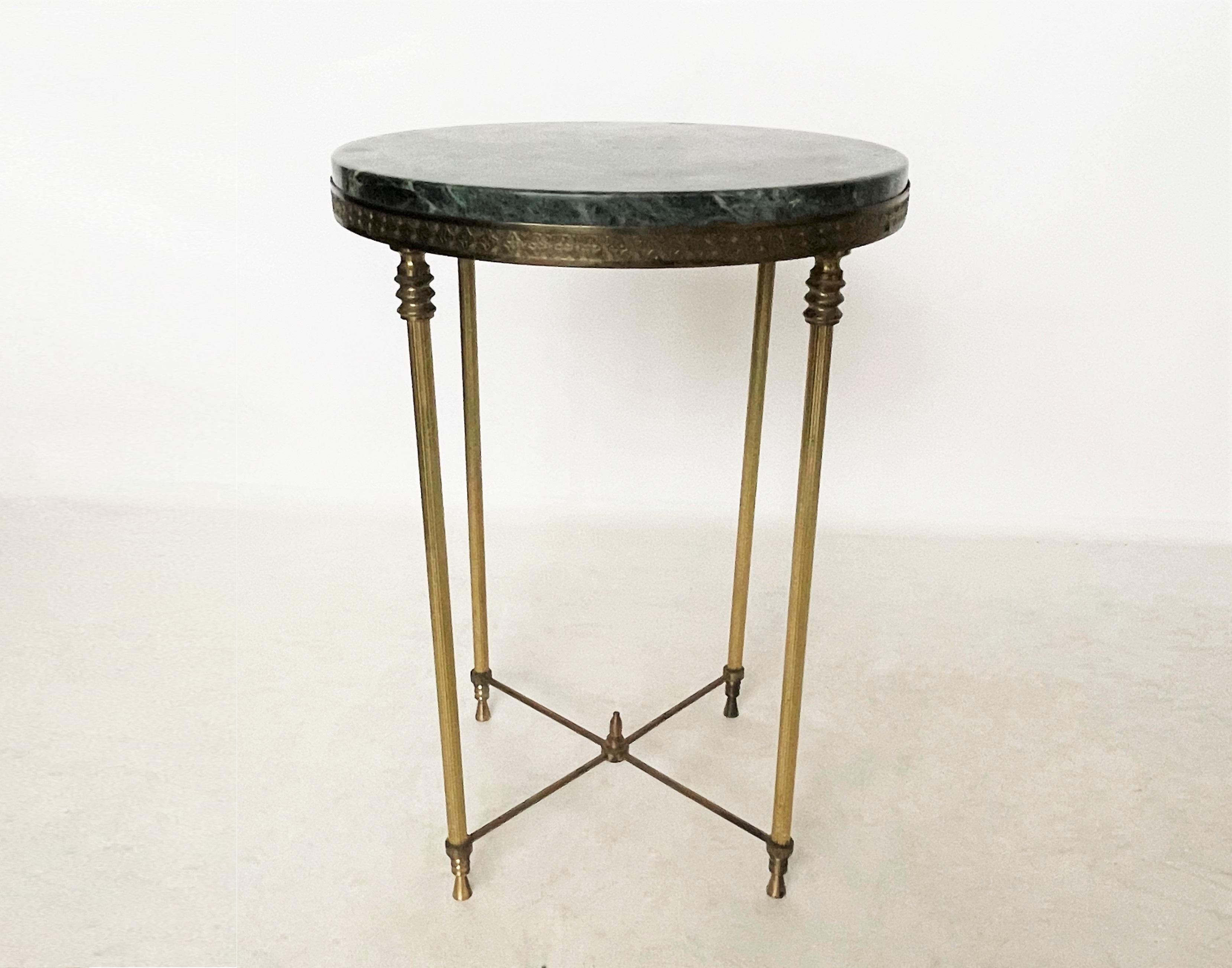 Regal, elegant, classy. This unbelievably beautiful drink/side table encompasses it all. Maison Jansen attributed, circa mid-20th century. The circular shaped marble top sitting inside a flat brass gallery. The marble is a gorgeous shade of emerald