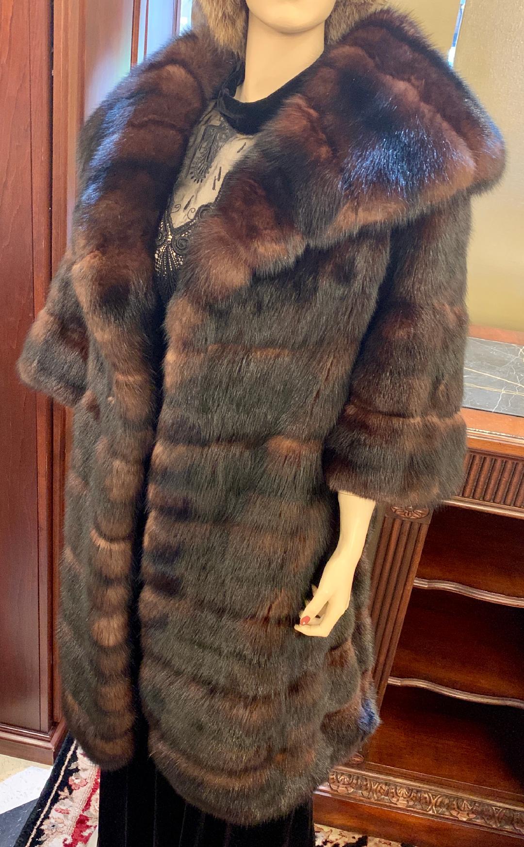 Very sophisticated and lavish, genuine regal Russian Sable fur coat features a large and very high fashion wide shawl style collar. The fur is a very rich, dark brown with beautiful shimmering lighter brown highlights - an indication of very