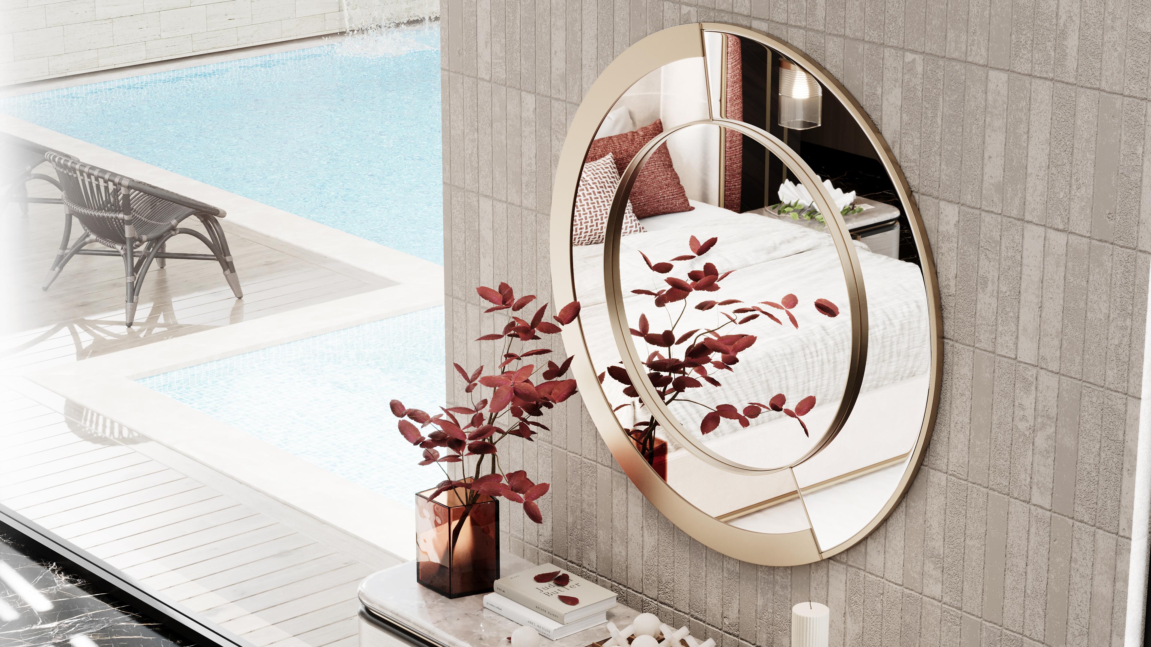 Zarok mirror is a sleek, round mirror with a clear and bronze finish, creating a sophisticated contrast. Its brushed brass structure adds a modern and luxurious touch to the piece. This simple yet elegant design makes it a versatile addition to any