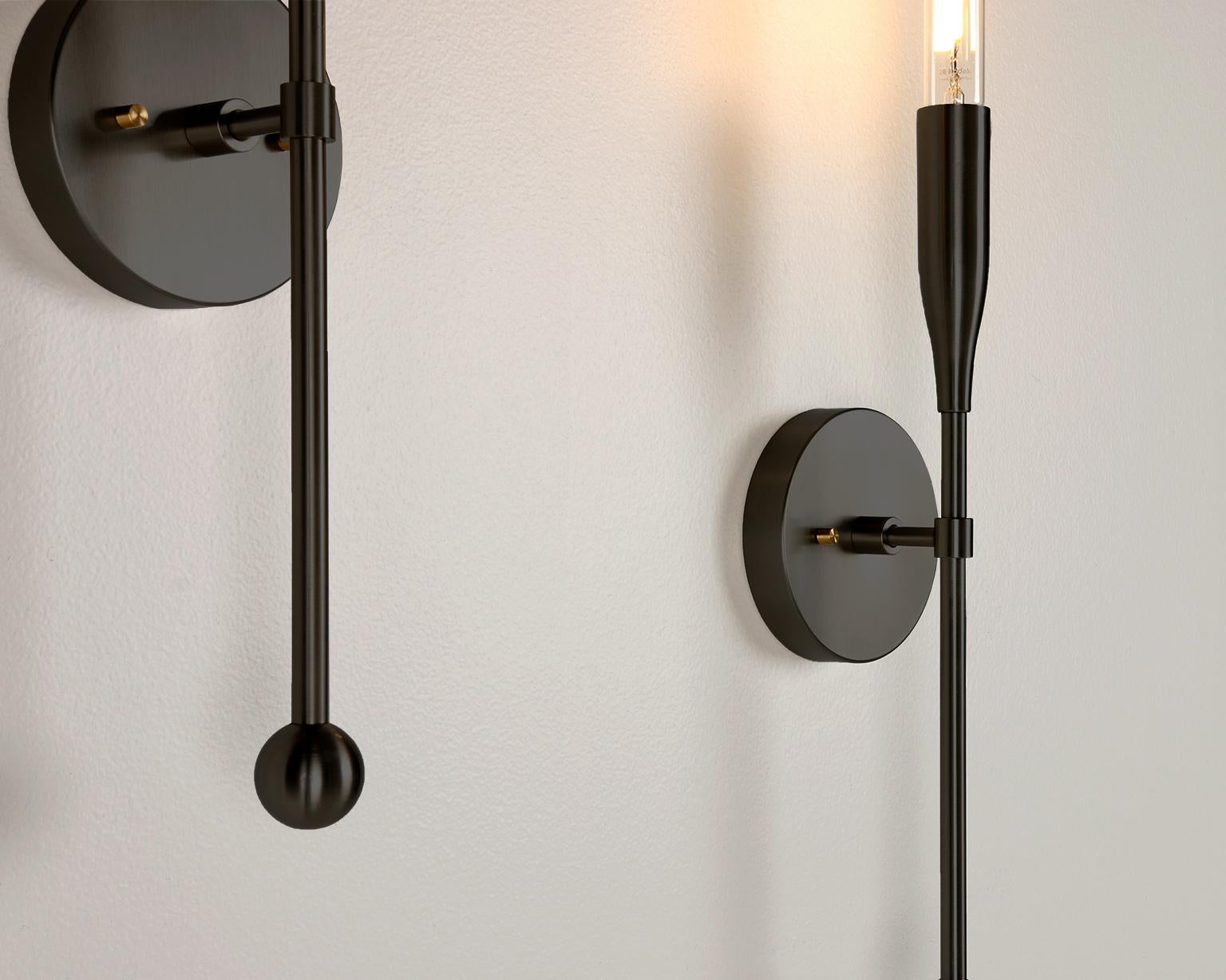 Our midcentury-inspired linear wall sconce is minimal and sophisticated. The fluted lines of this contemporary light fixture create a versatile choice for accent or task lighting. With an exposed bulb, sweeping curves, and clean lines, the design
