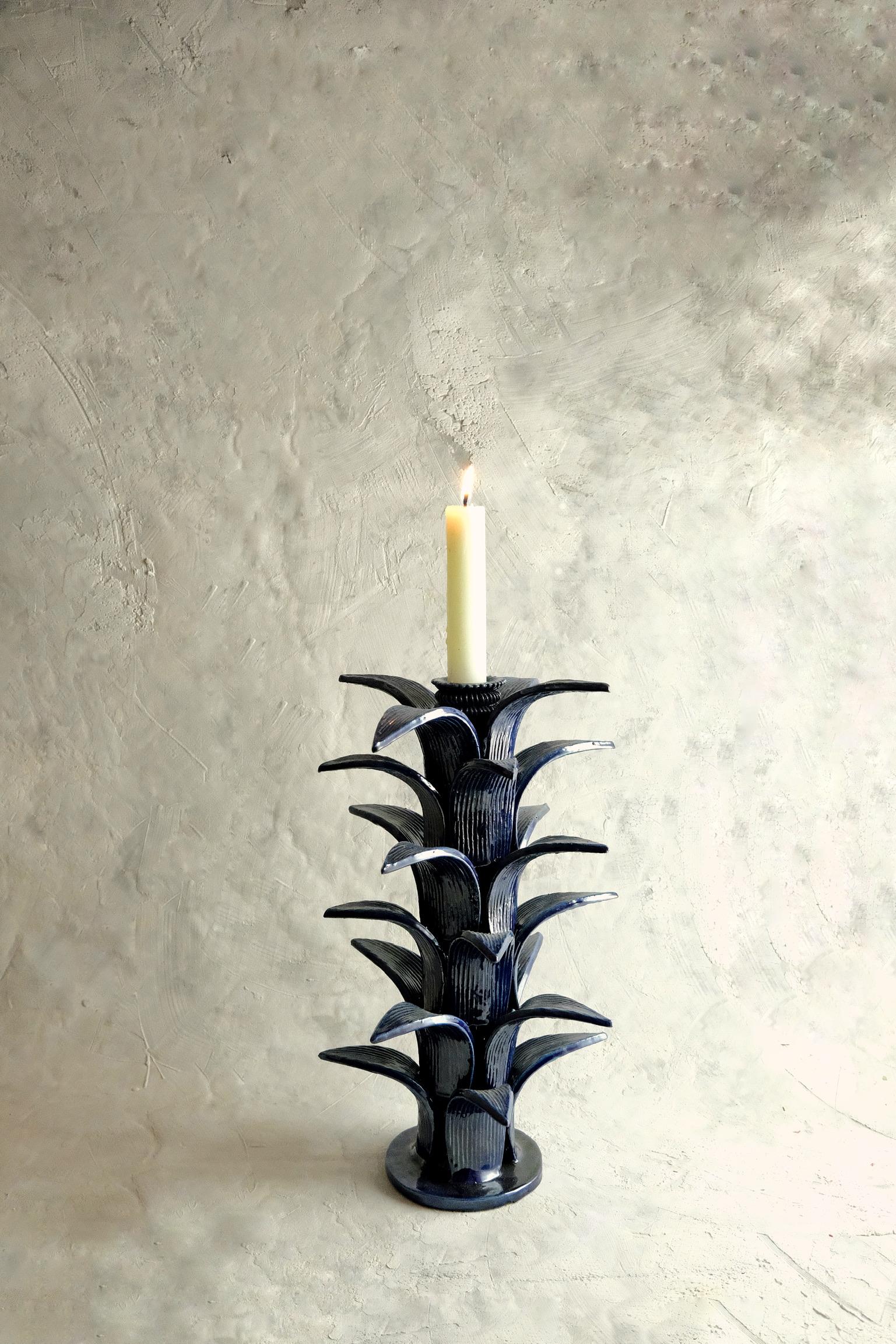 Sorgo candleholder by Onora
Dimensions: D 23 x H 38 cm
Materials: Clay, Quartz stone

Available in black, green, blue and yellow. 
Hand made in the town of San Jose de Gracia, Michoacan, Once the piece has been completely molded, a white based