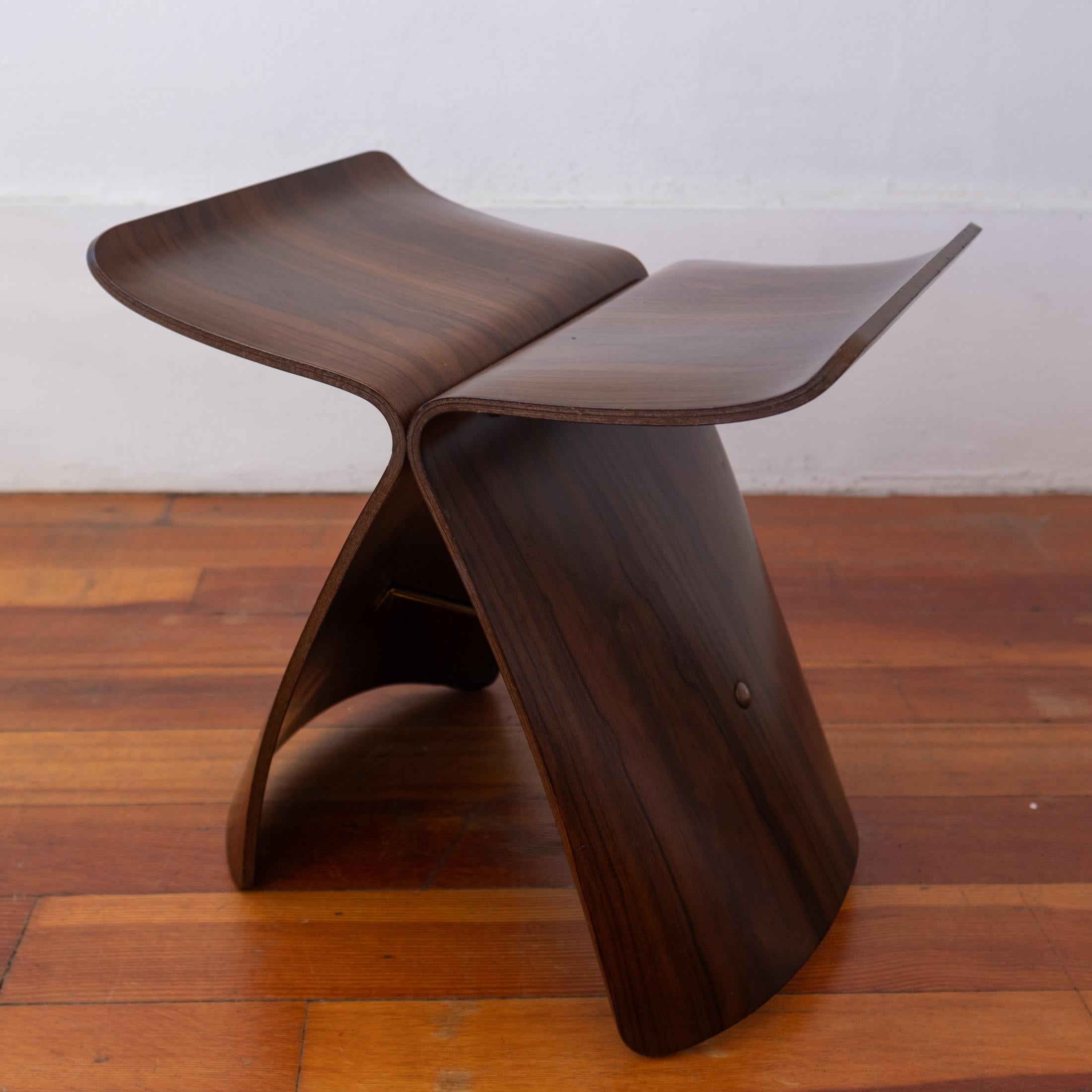 Sori Yanagi Butterfly Stool in rosewood and brass. Designed in 1954 and produced in the 1990s. Signed, Sori Yanagi.  
