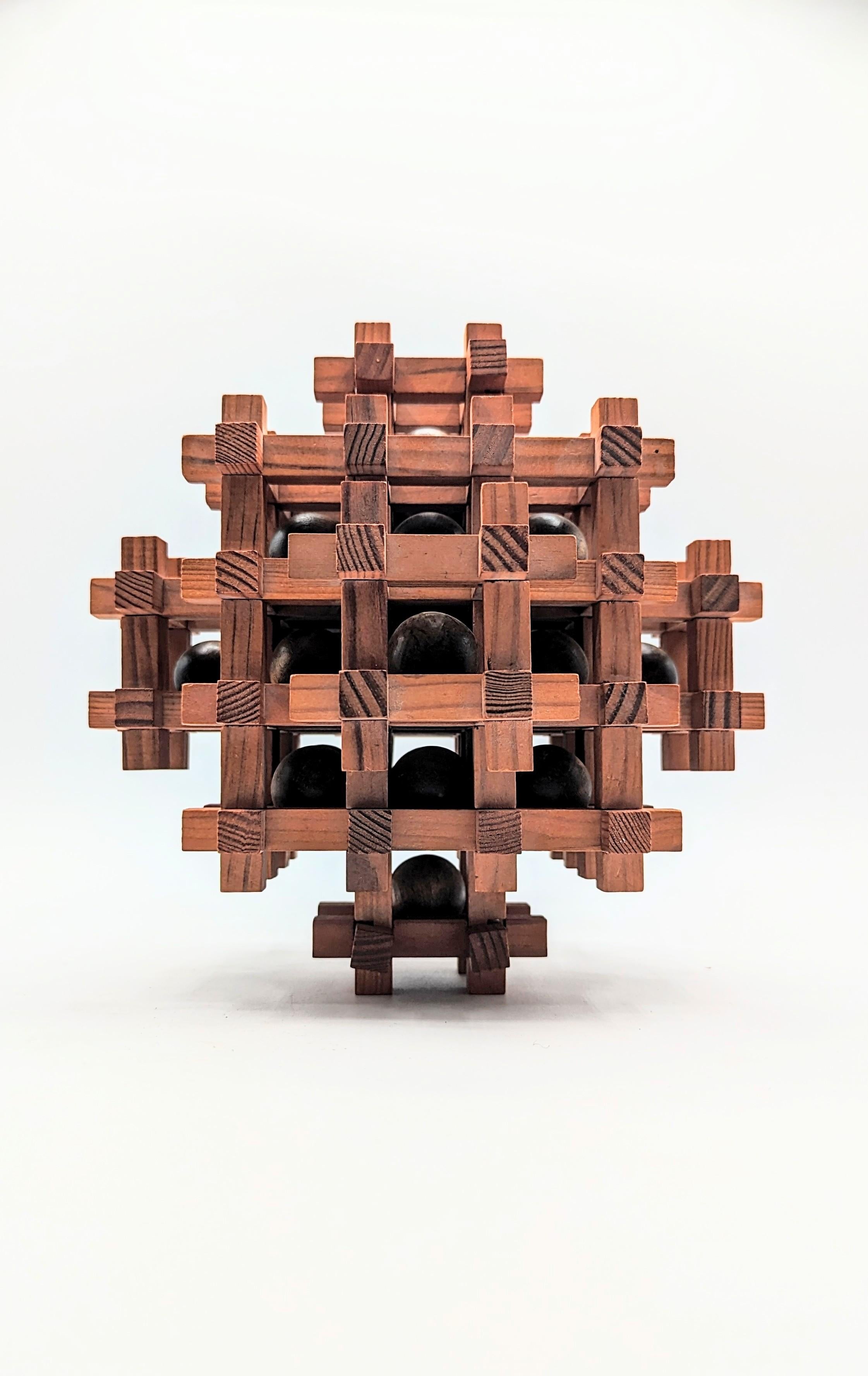 This 5-level, oversized wood puzzle sculpture was made by Sori Yanagi (the designer of the famous butterfly and elephant stools). Yanagi designed a limited series of puzzles, so they are very collectible and hard to find.

Sori was the son of the